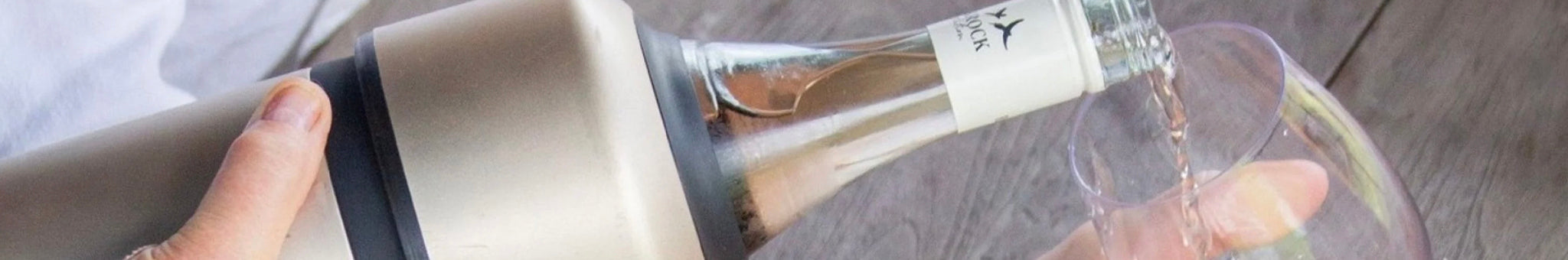 Alt Tag: Huski insulated wine cooler sleeve keeping bottle cold while pouring into glass