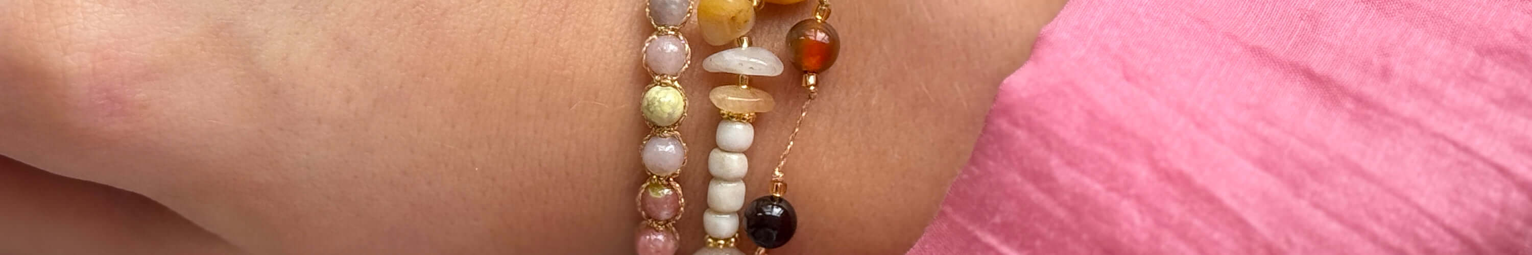 Close-up of a hand wearing beautiful beaded bracelets from the Margaret collection, showcasing timeless elegance.