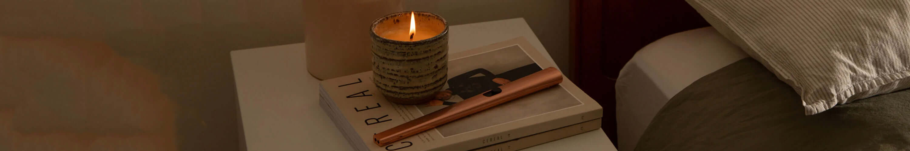 Flint rechargeable lighter on bedside table lighting candle, sleek sustainable design for everyday home moments