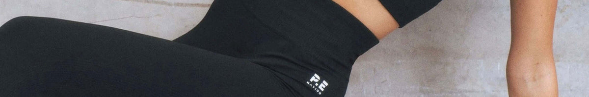 P.E Nation women’s activewear leggings close-up with logo waistband, sleek athleisure style from the P.E Nation collection