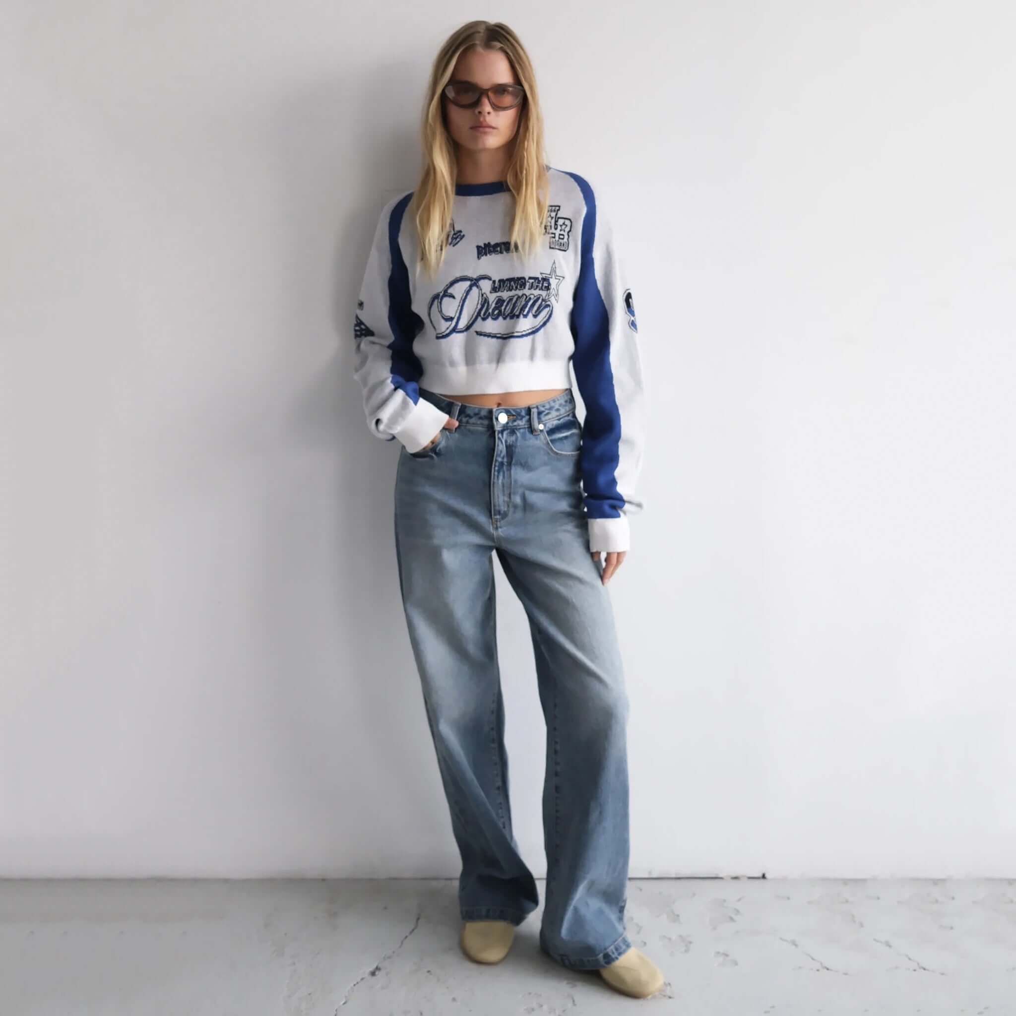 Woman wearing Abrand 94 High & Wide Jeans in Selena.