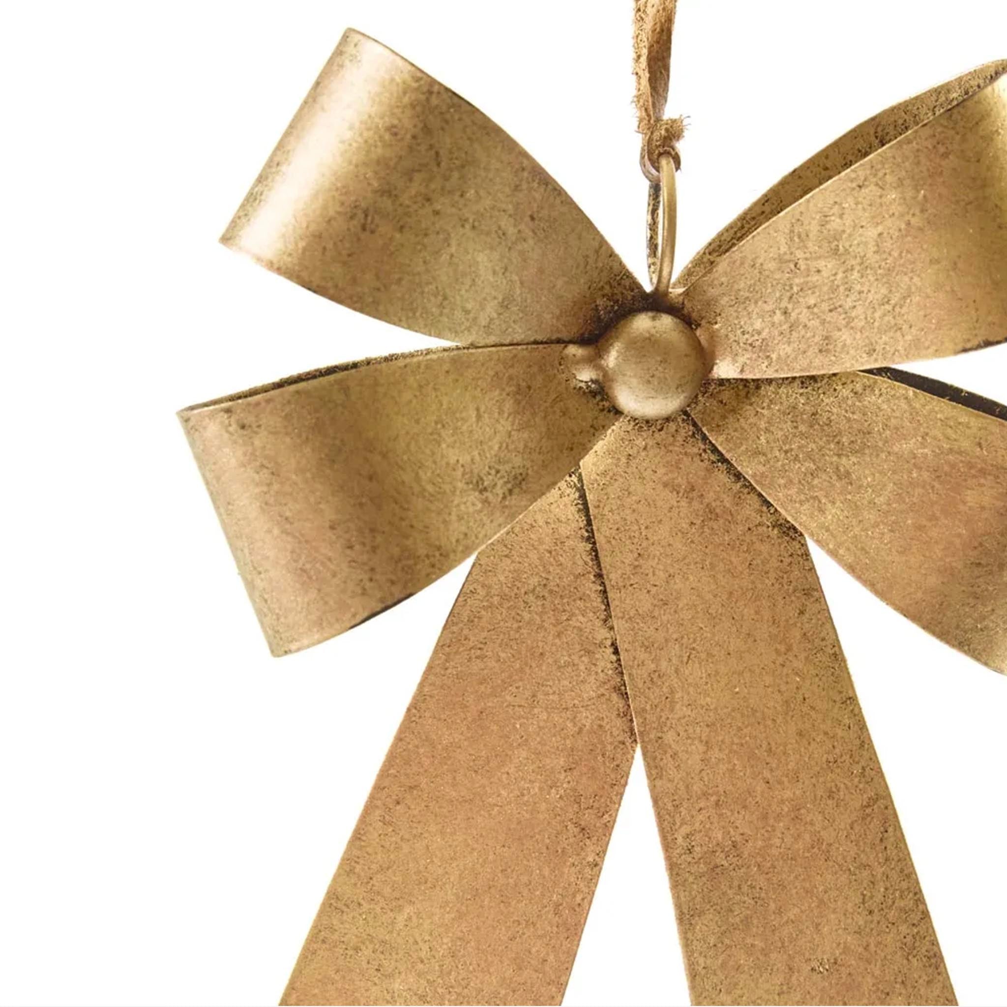 Gold bow ornament on a white background