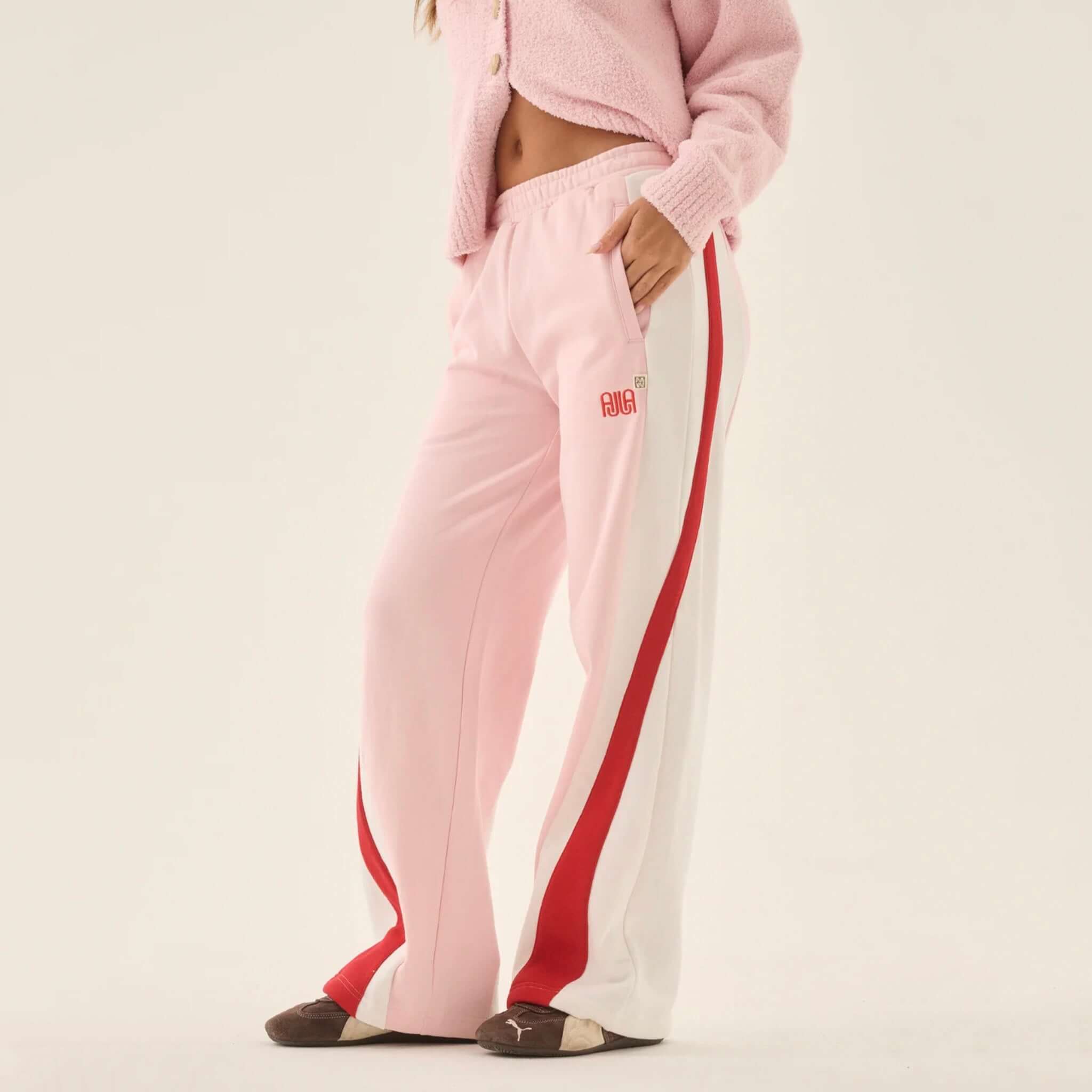 Araminta James Mallorca Trackpants - Ballet Pink paired with a soft pink cardigan, showcasing color-blocked side panels.