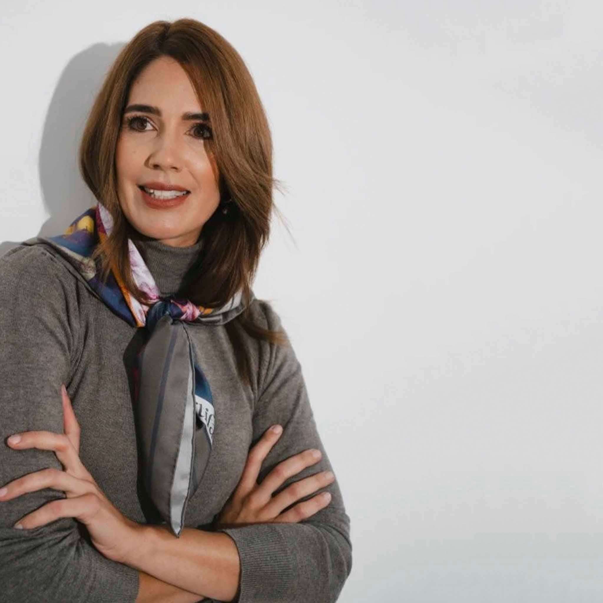 Alt Tag: Artifact Square Silk Scarf - Pomona Harvest worn as neck scarf, botanical fruit print on neutral background, styled on model