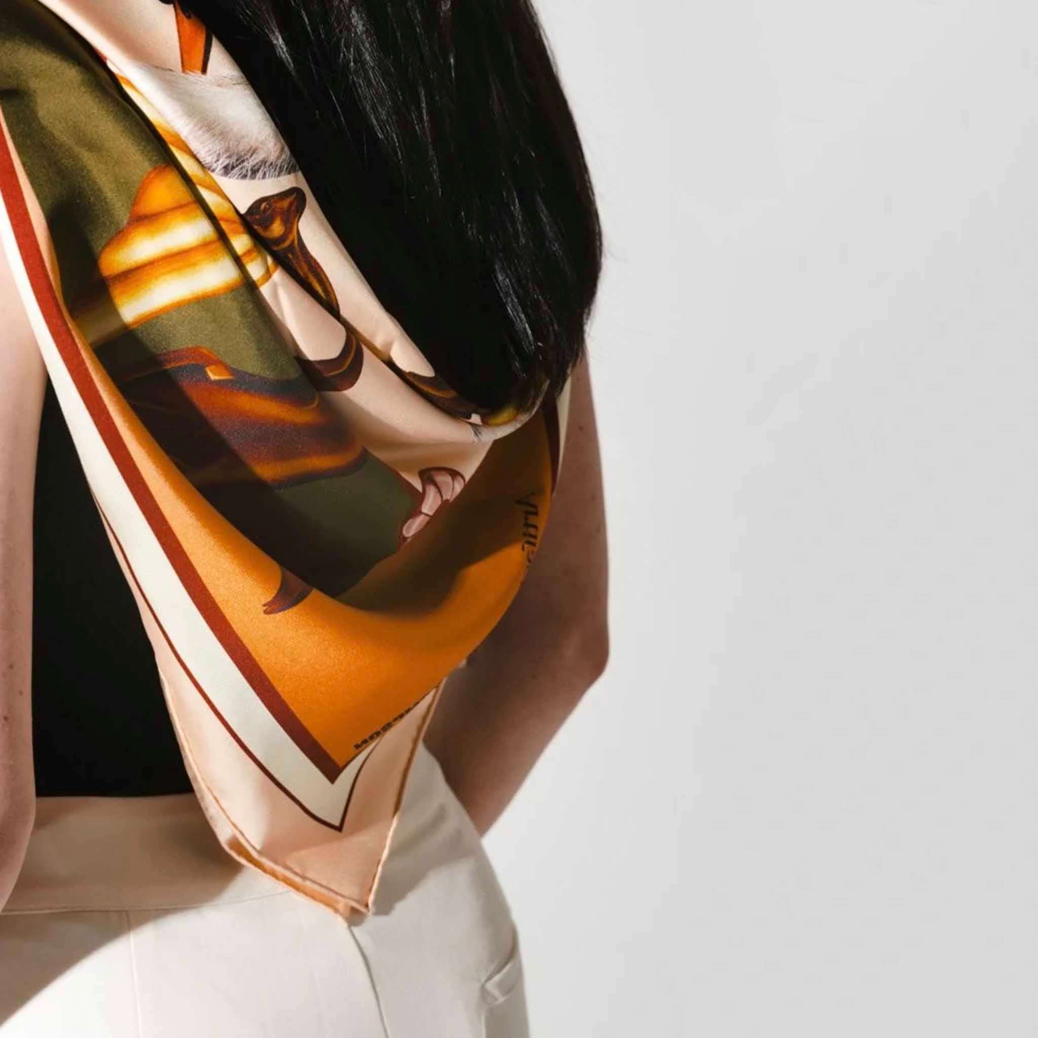 Alt Tag: Artifact x Kelly Thompson Square Silk Scarf - Gilded worn as neck scarf, gilded swan and gazelle print 18mm silk twill