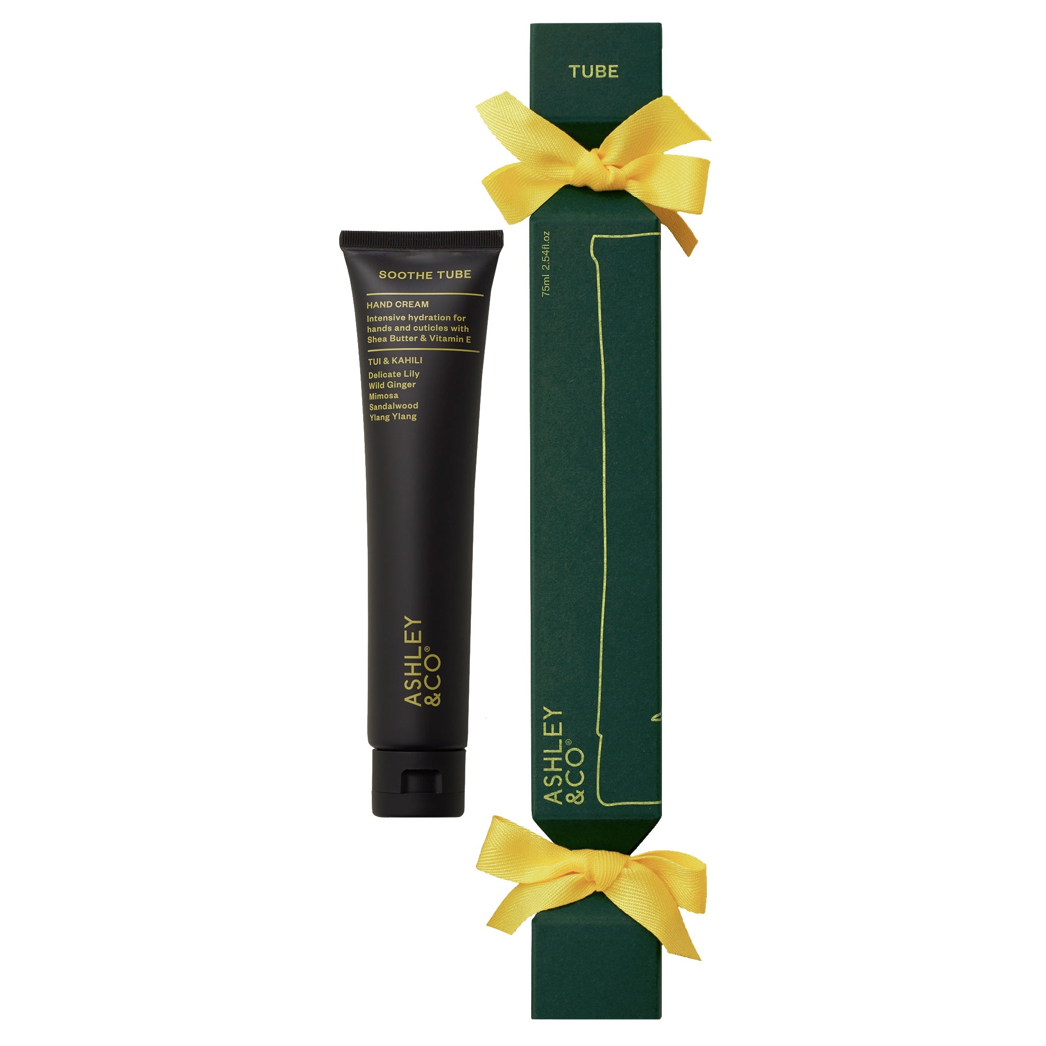 Black tube of cream with green packaging and yellow ribbons on a white background