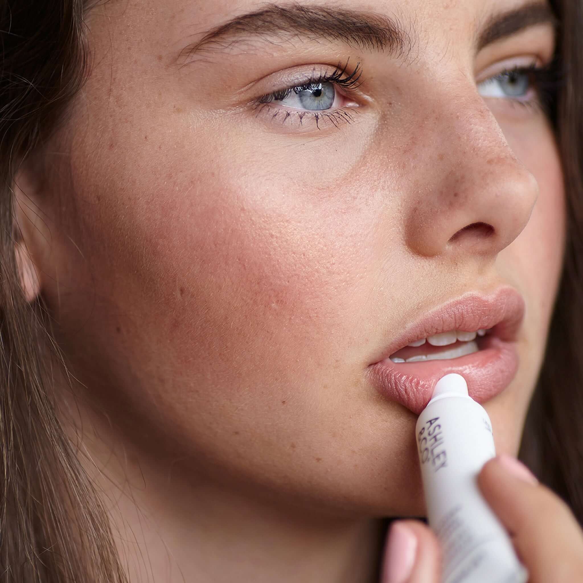 Ashley & Co Lip Punch Intensive Lip Balm applied to lips, nourishing natural beeswax balm for dry chapped lips, 15ml made in New Zealand