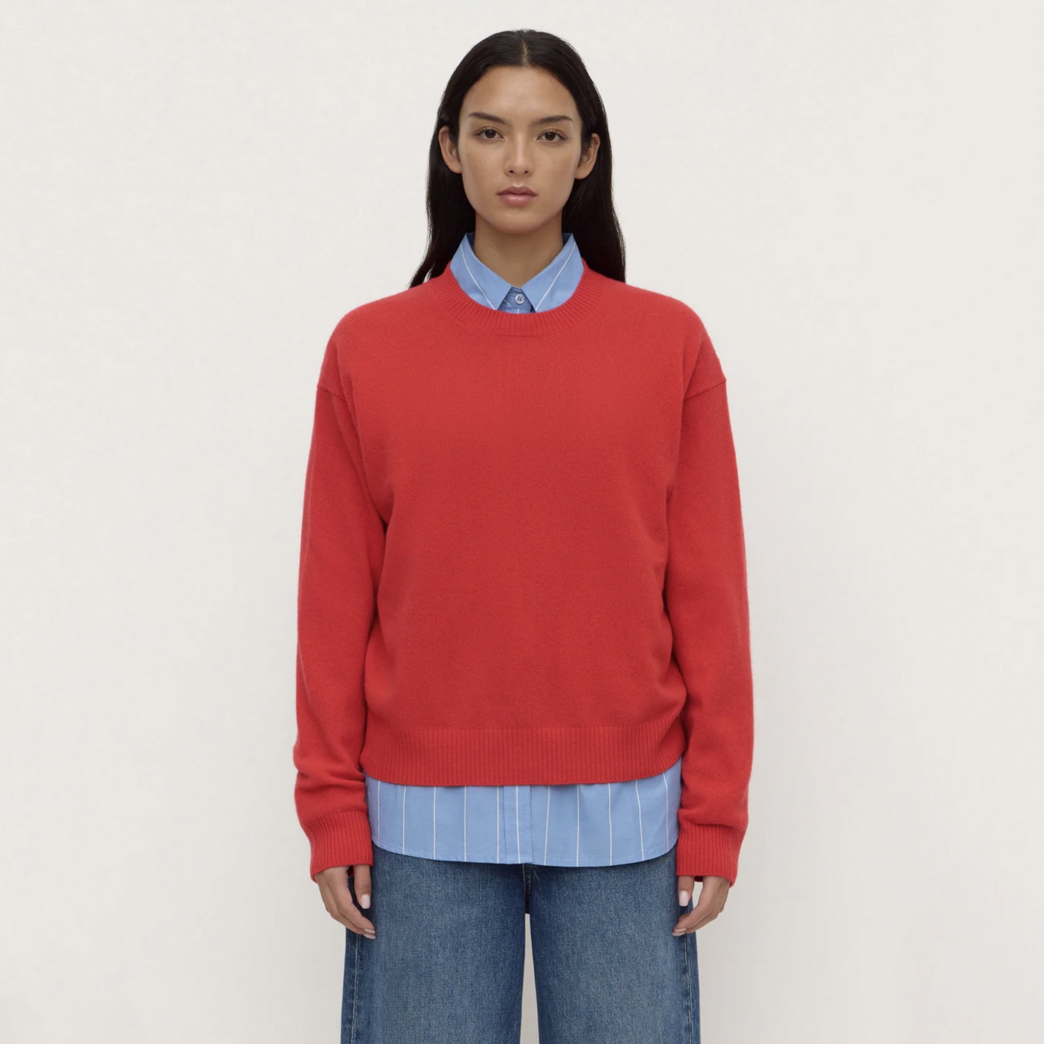 Assembly Label Carter Brushed Merino Wool Sweater - Flame worn over a light blue shirt with casual jeans.