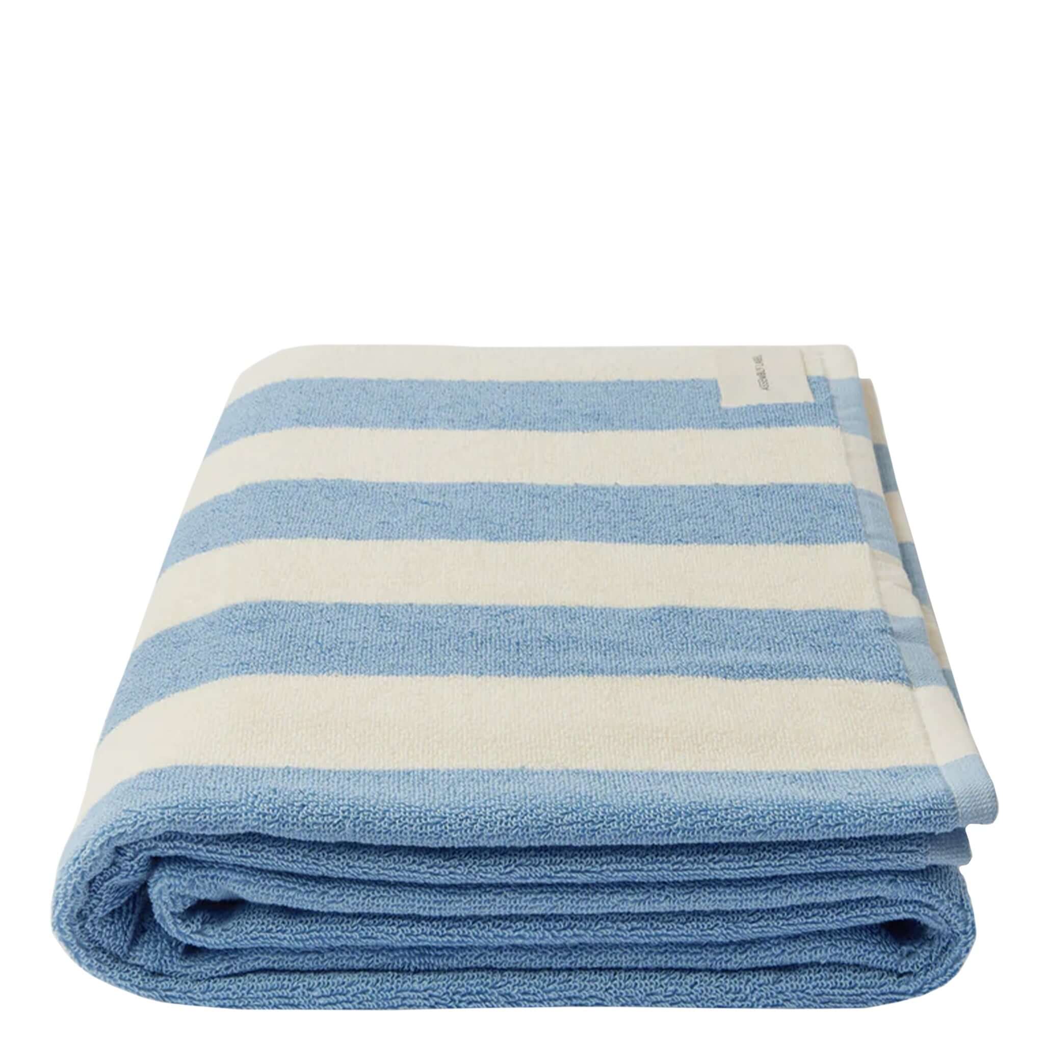 Folded blue and white striped towel on a white background