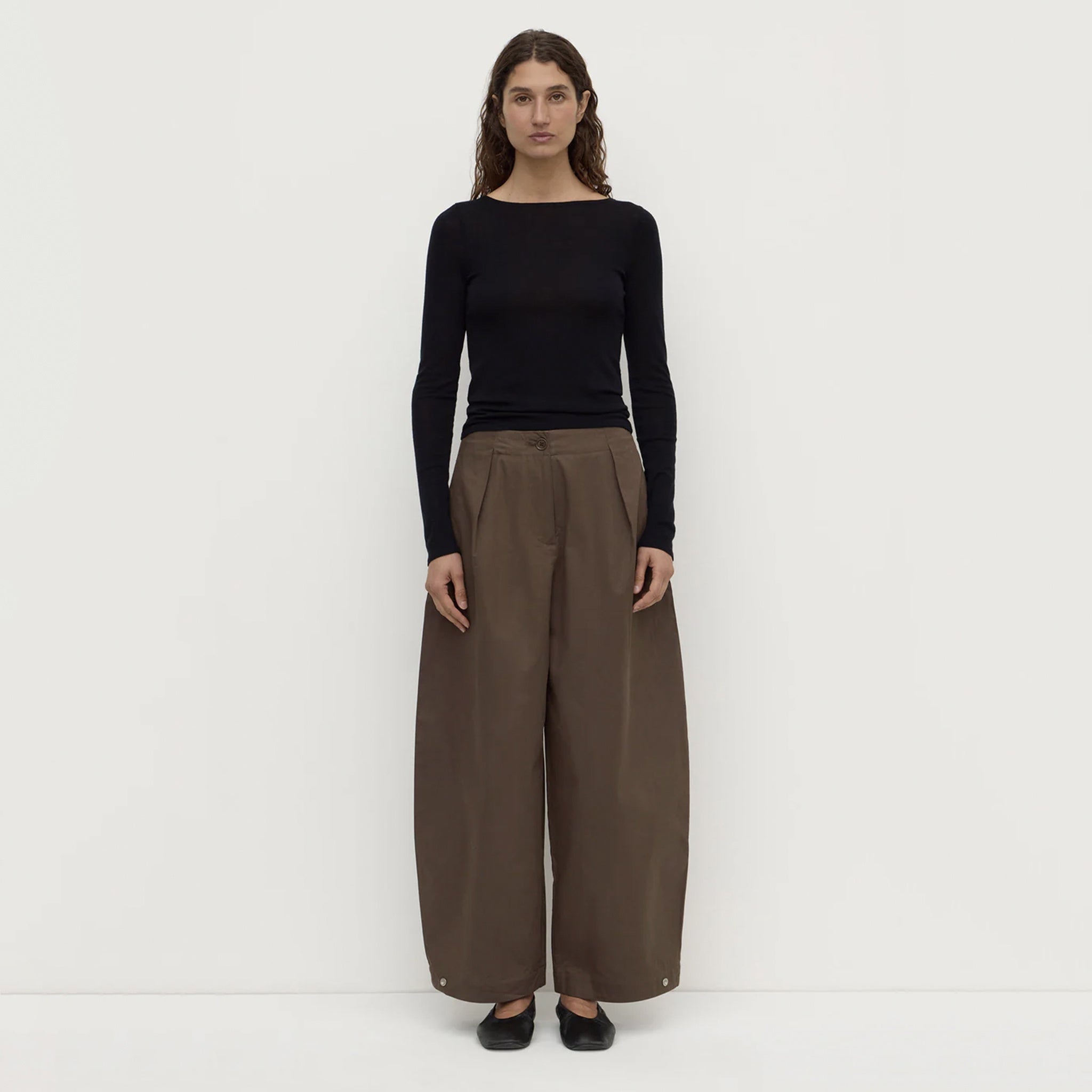 Assembly Label Jasmine Cotton Adjustable Barrel Leg Pants - Military modeled by a woman in a black long sleeve top.