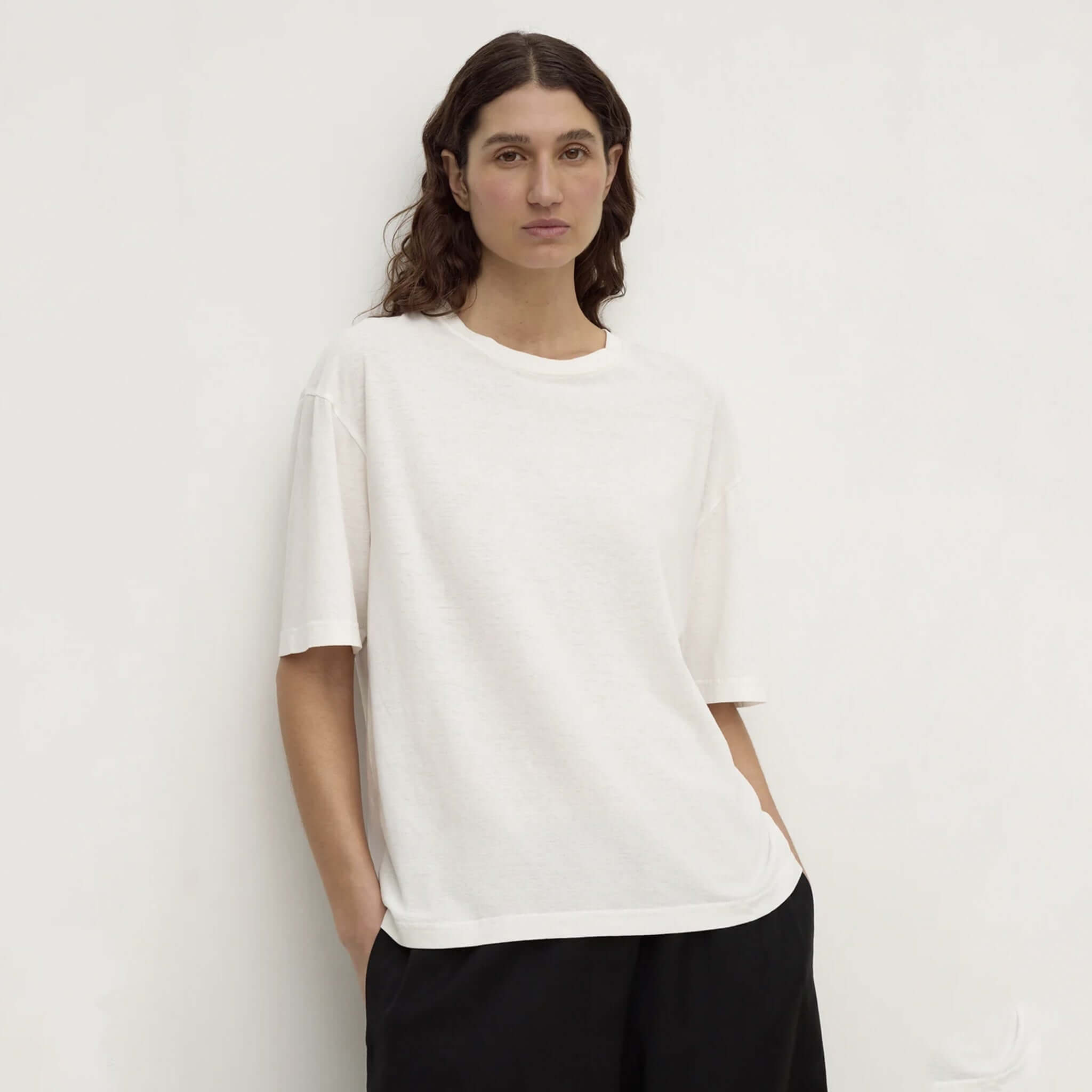 Assembly Label Kira Cotton Hemp Tee - Antique White on a model, showcasing its relaxed style and natural texture.