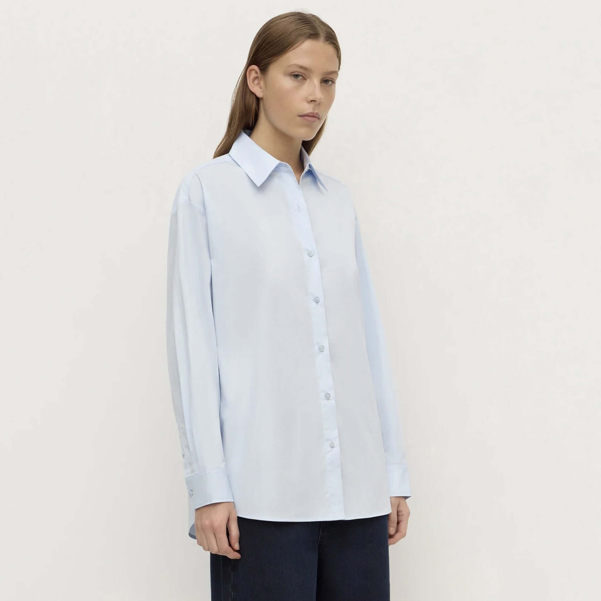 Assembly Label Micha Poplin Long Sleeve Shirt - Powder Blue worn by a model, showcasing a classic collar and refined silhouette.