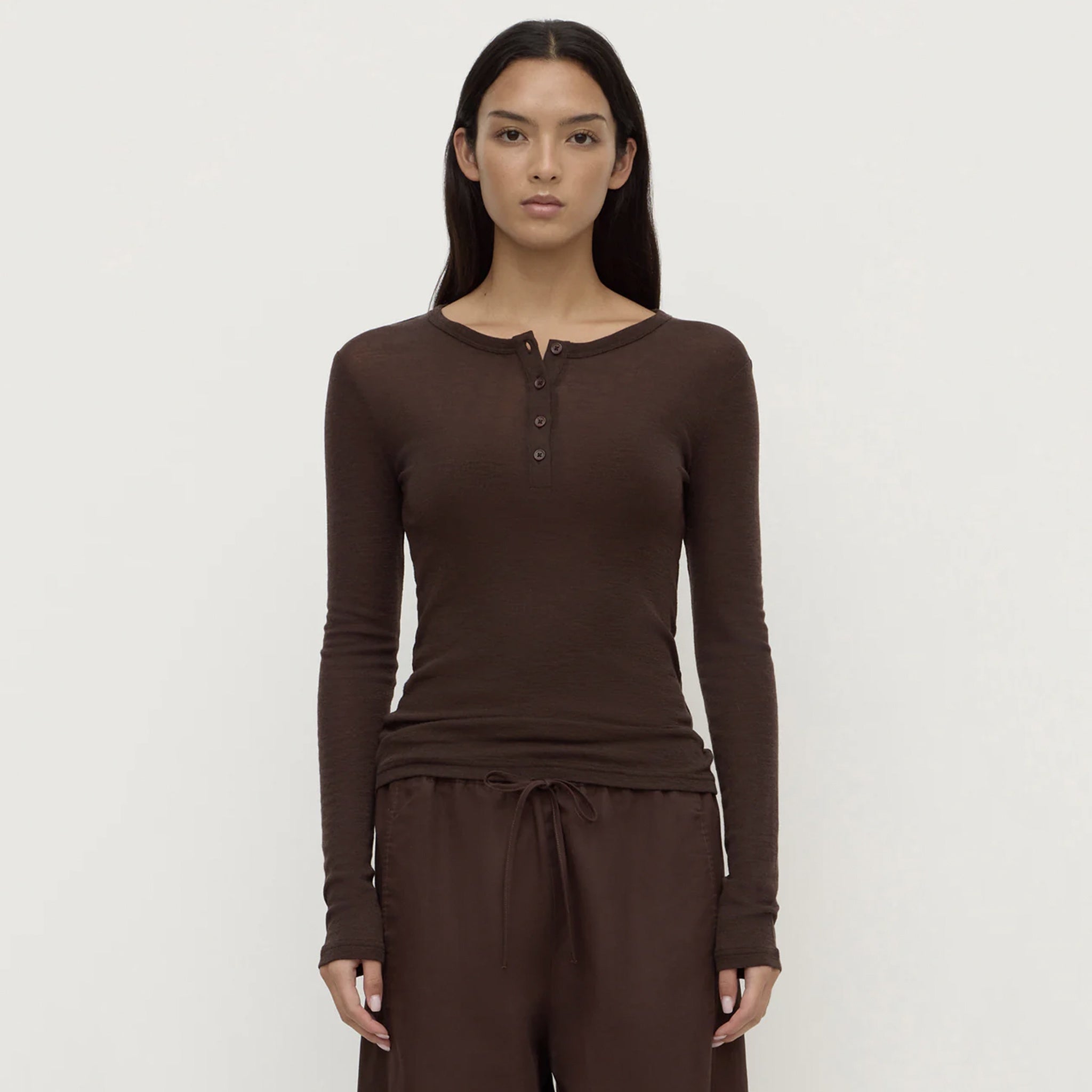Assembly Label Nora Merino Wool Henley Top - Ganache on a model, showcasing its fitted design and Henley neckline.