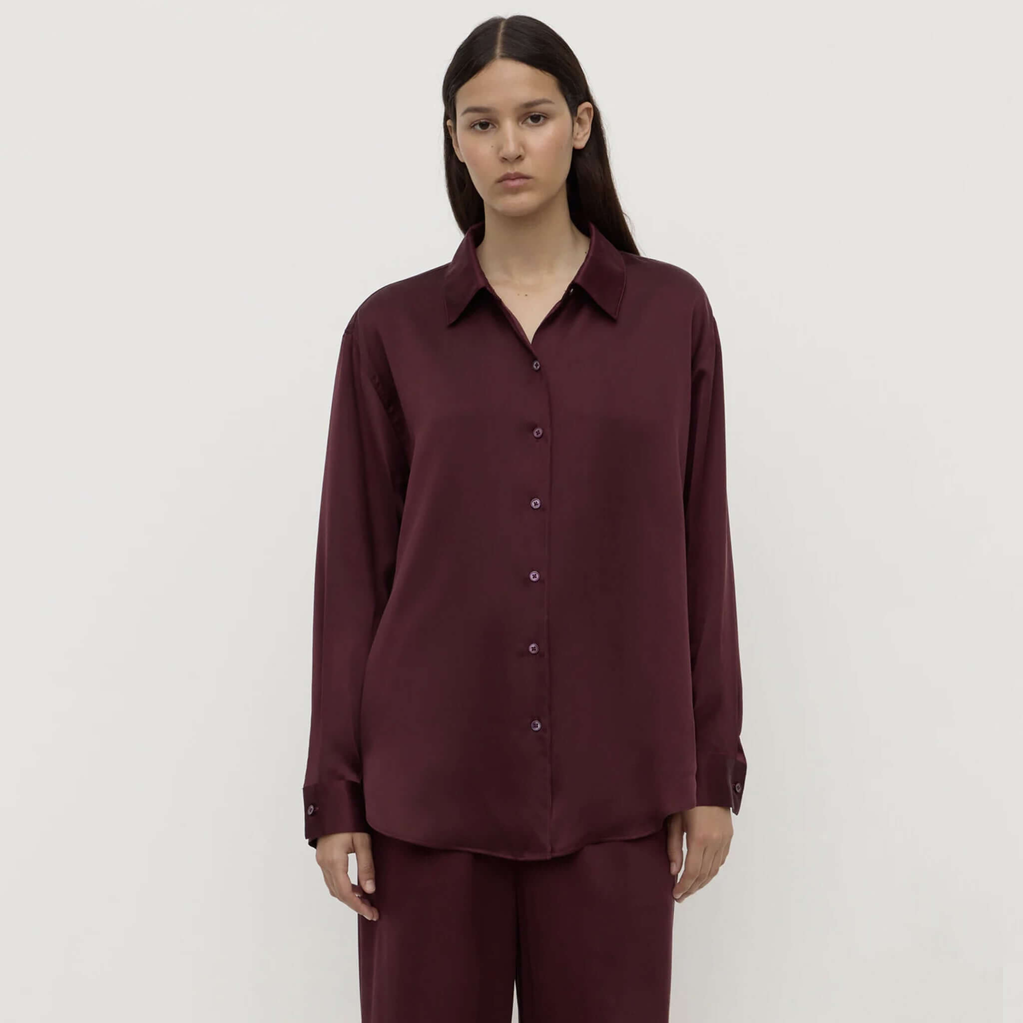 Alt Tag: Assembly Label Pippa Silk Long Sleeve Shirt - Merlot on model, 100% silk relaxed fit women’s long sleeve button-up with classic collar