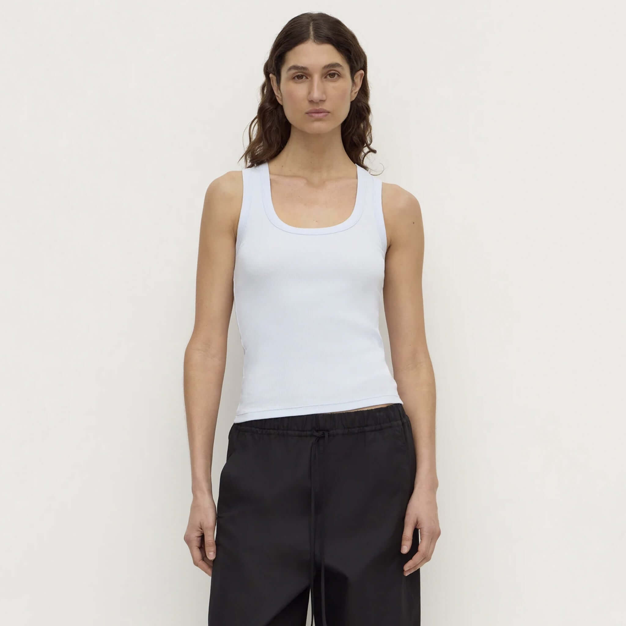 Assembly Label Robyn Scoop Neck Rib Tank - Powder Blue worn by model with black pants.