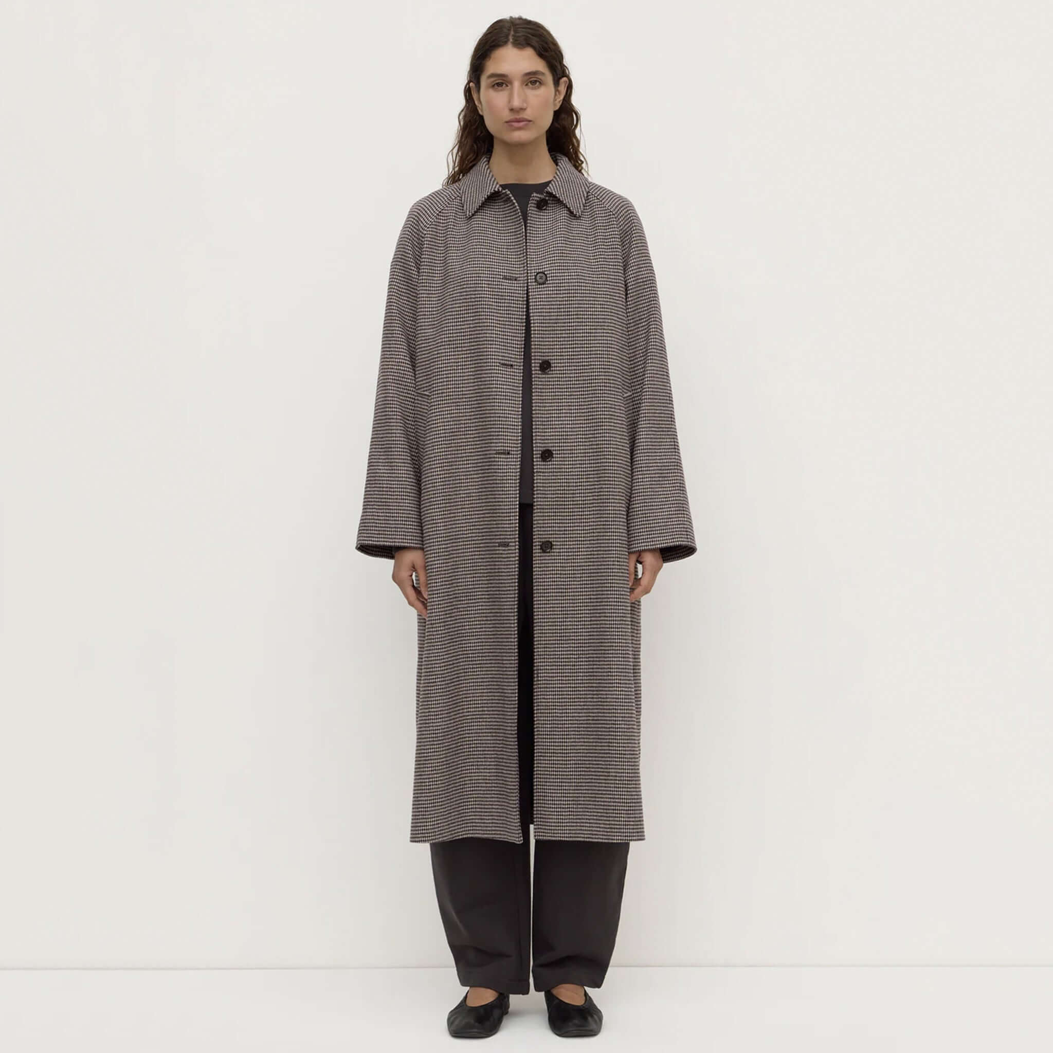 Brown black check wool coat by Assembly Label, featuring a long, modern silhouette with button-front fastening.