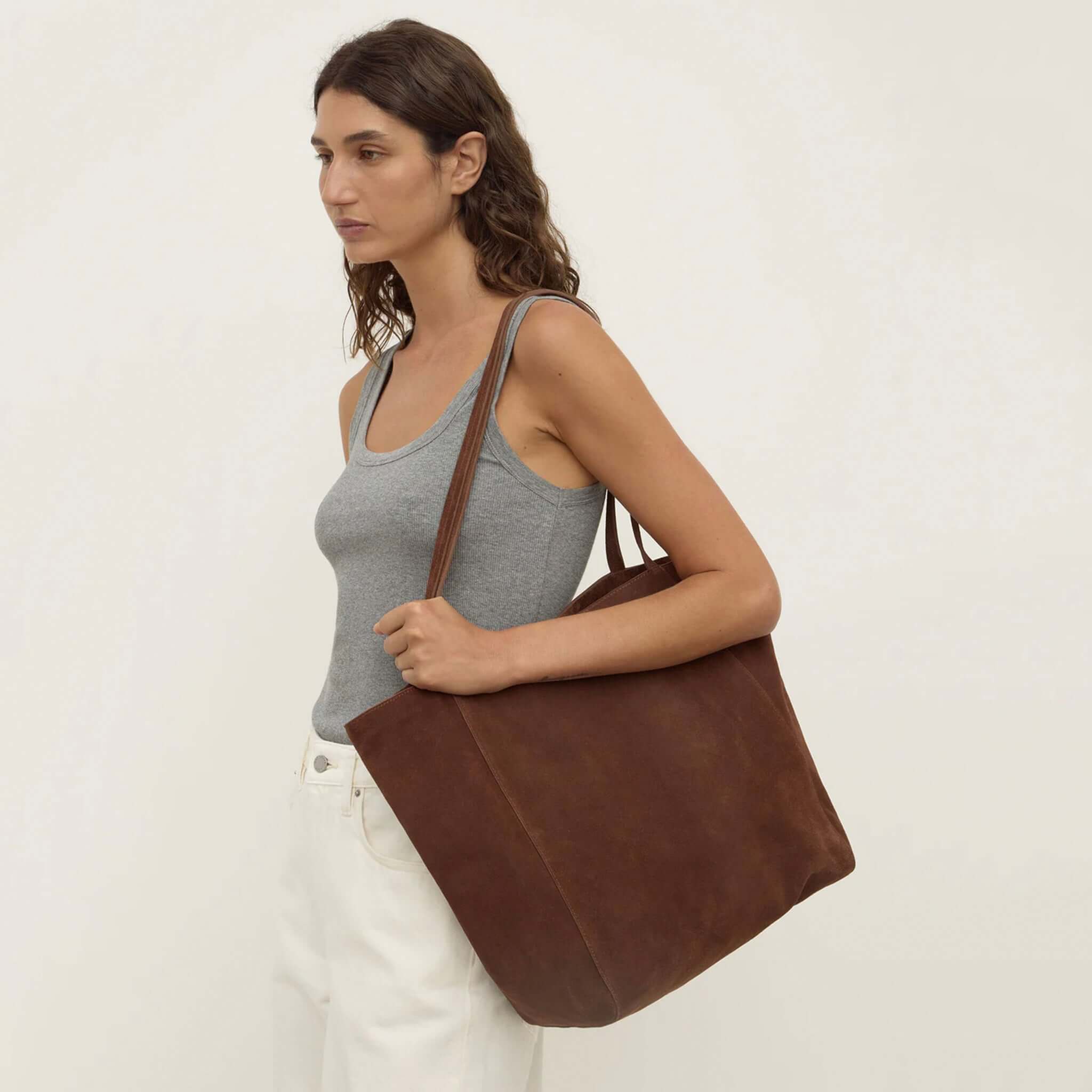 Alt Tag: Assembly Label Paige Suede Tote Bag - Amaro on model, brown suede unstructured shoulder tote with slim straps