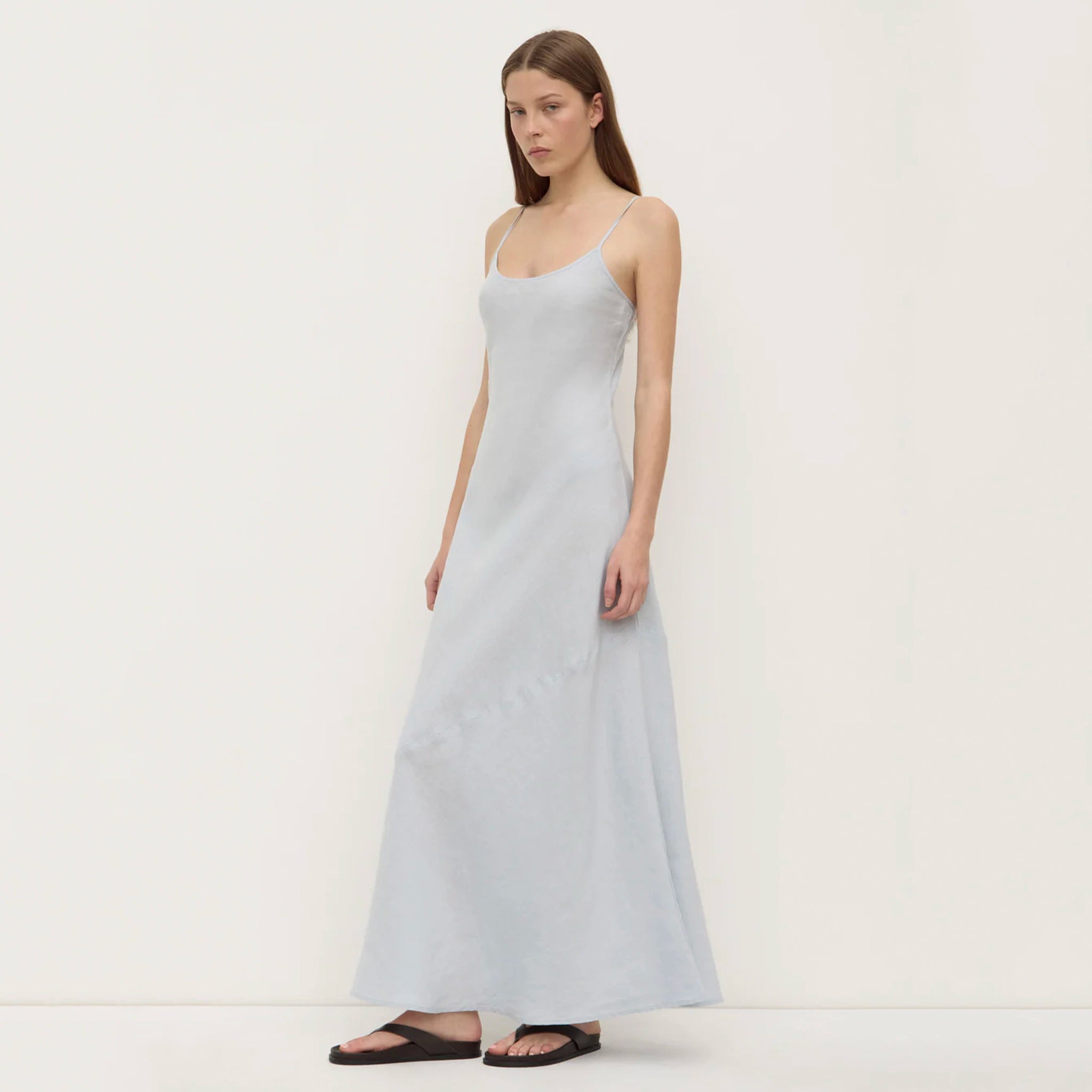 Woman wearing a light blue dress on a white background