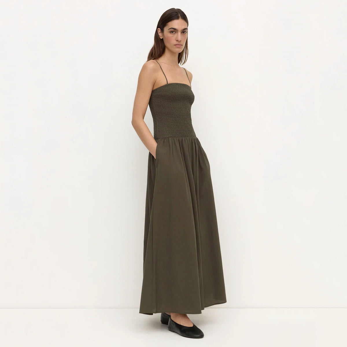 Assembly Label Connie Cotton Shirred Dress - Dark Military, front view on model with hands in side pockets