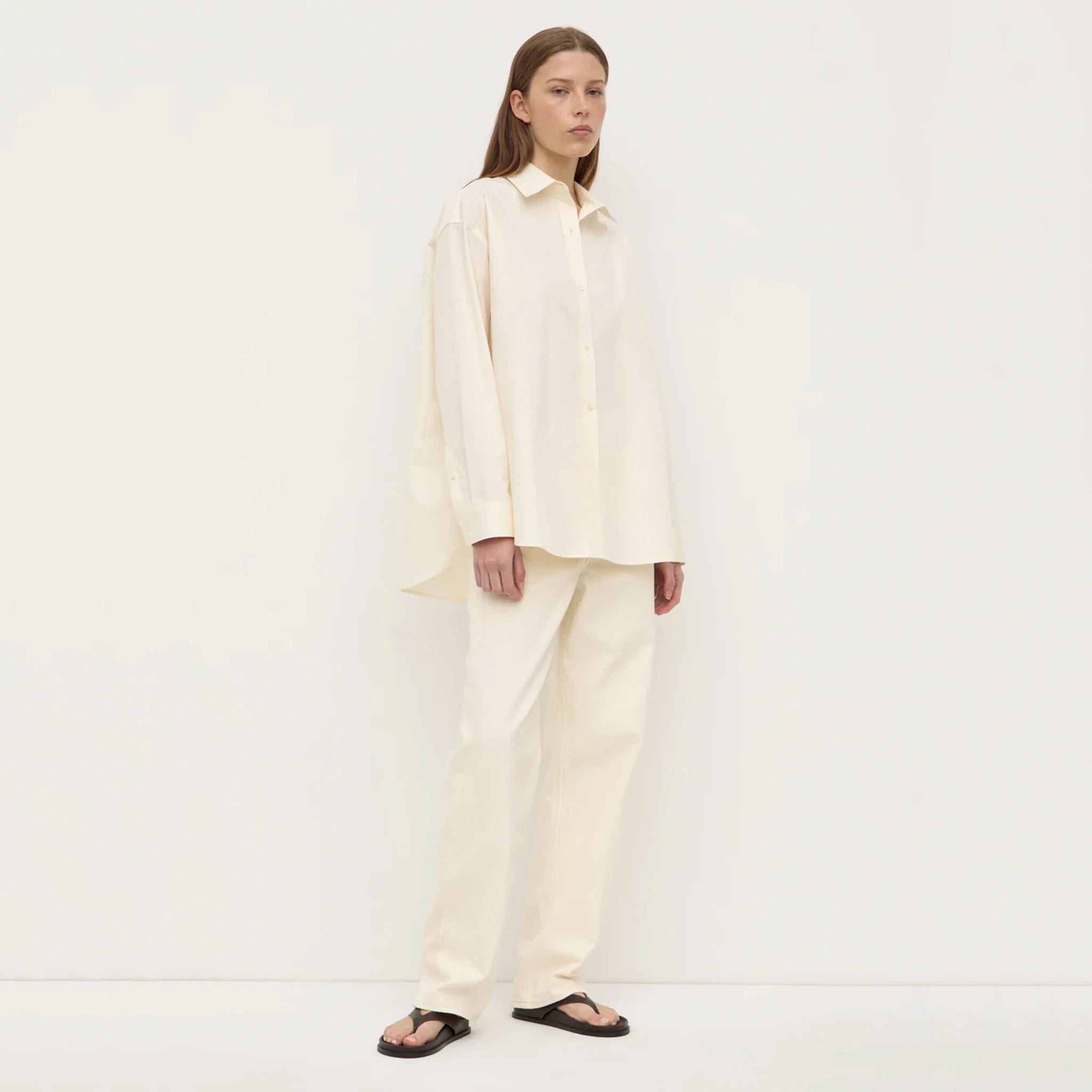 Person wearing a cream-colored outfit on a white background