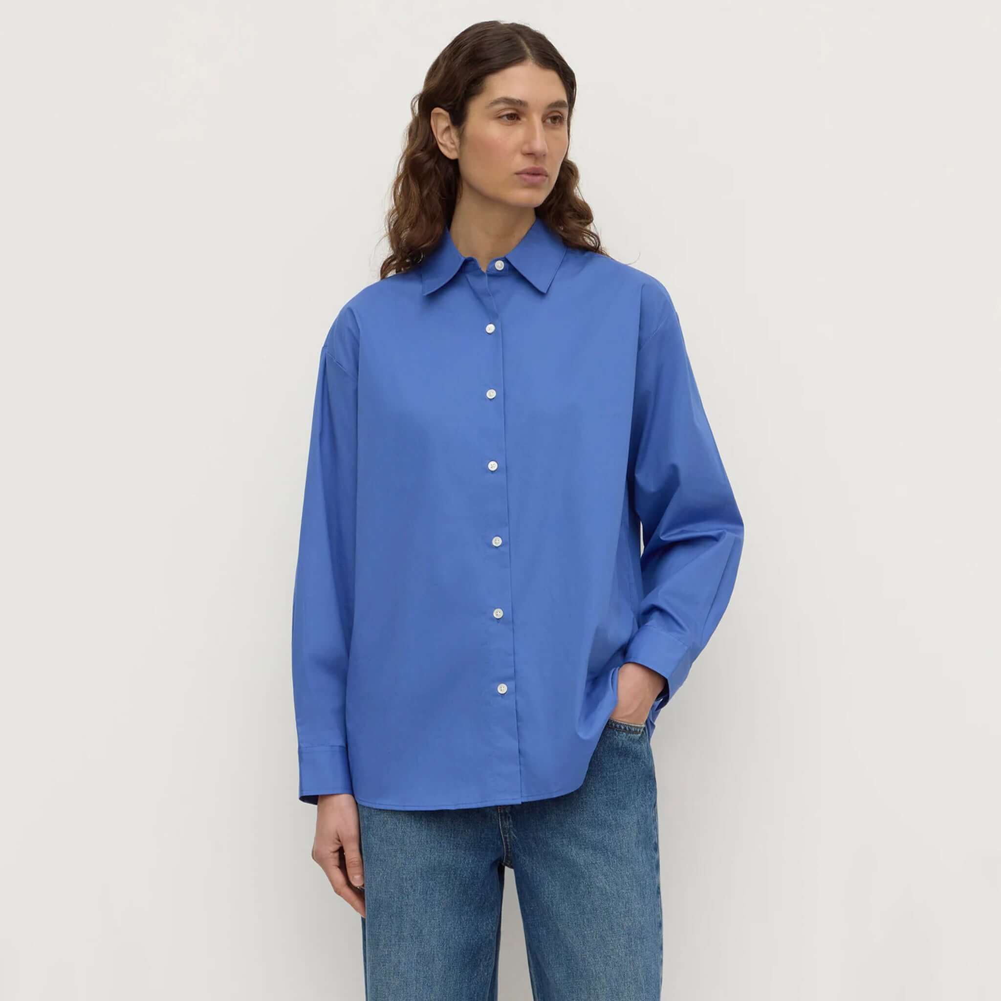 Assembly Label Micha Poplin Long Sleeve Shirt - New Blue worn by a model with button-up design and relaxed fit.