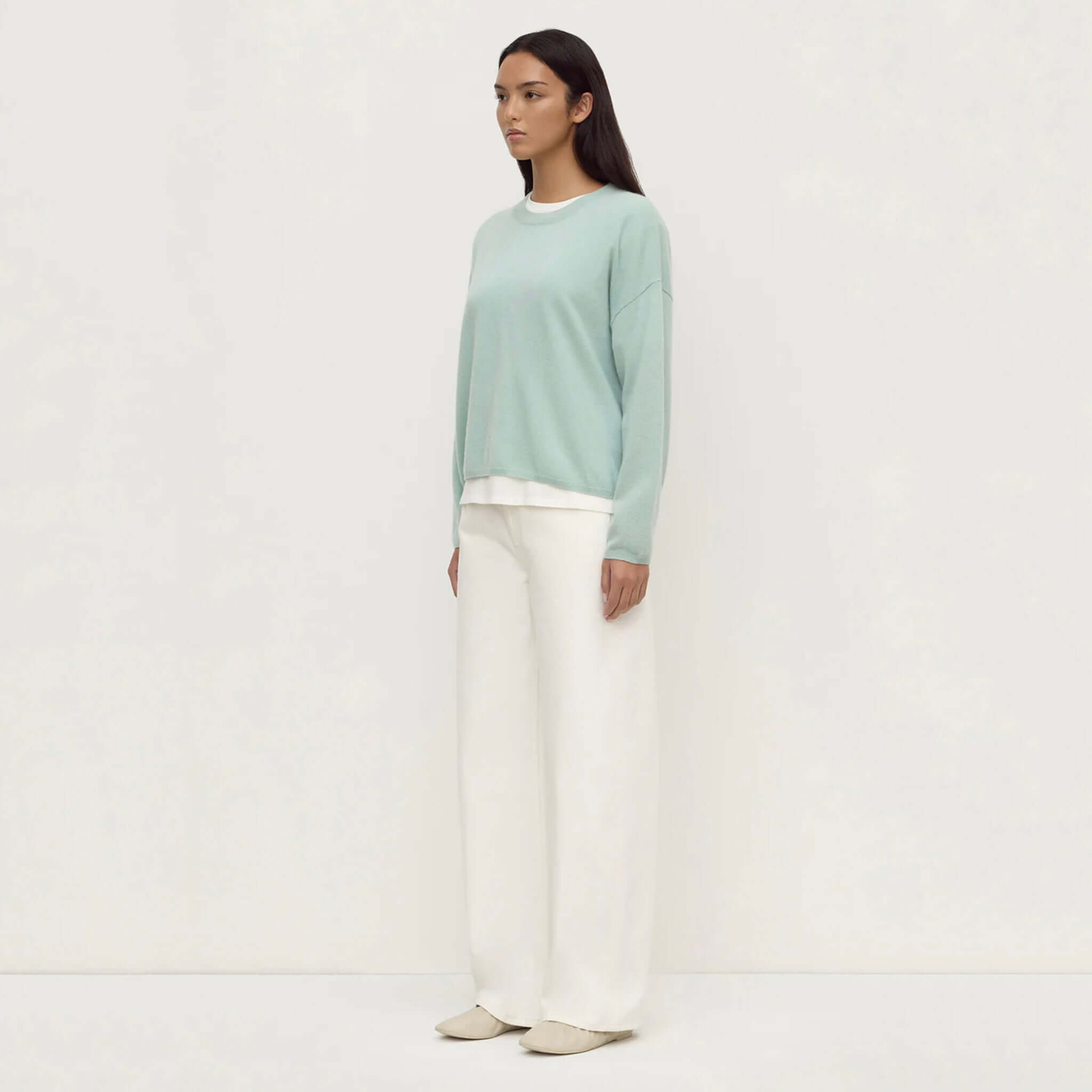 Model wearing Assembly Label Odelle Cashmere Knit Jumper - Mint with wide-leg pants and relaxed fit.
