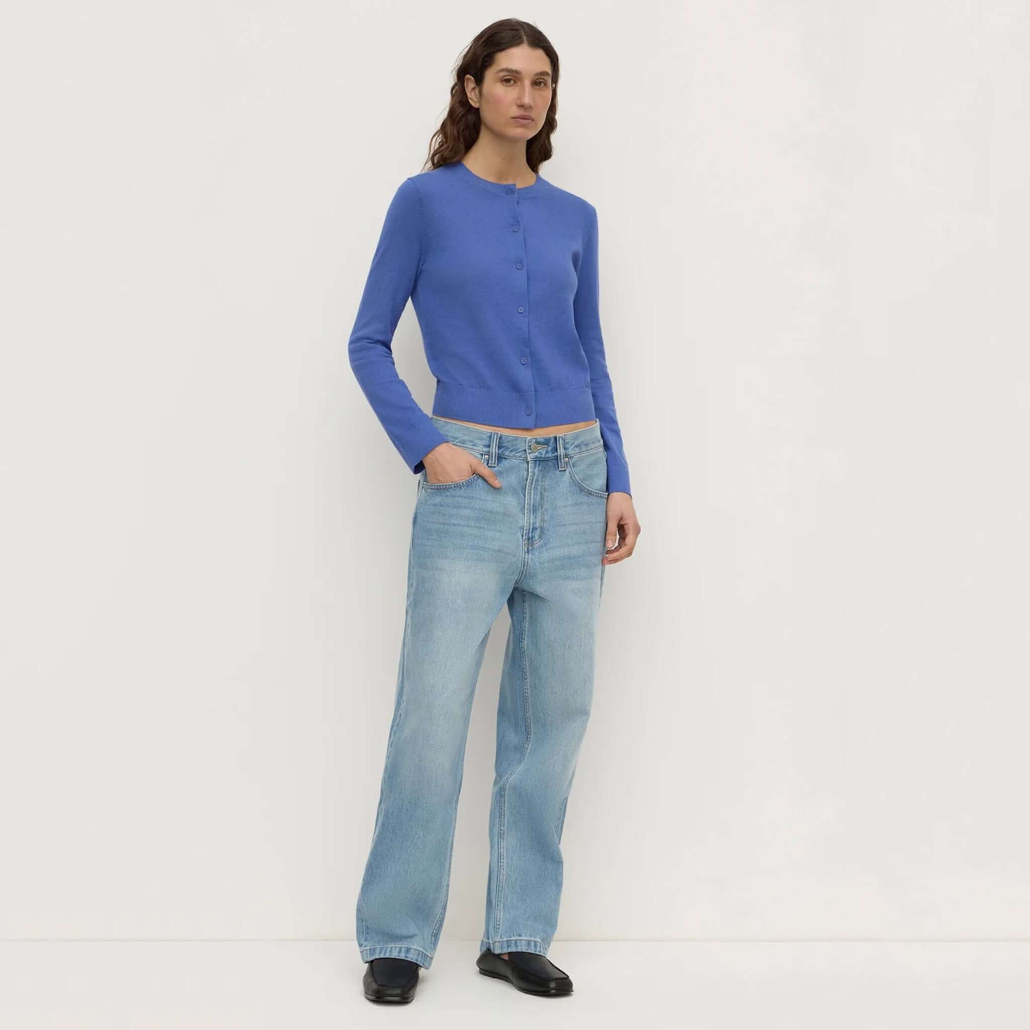 Assembly Label Orina Cotton Cashmere Cardigan - New Blue worn with light-wash denim, showcasing cropped silhouette and elegant style.