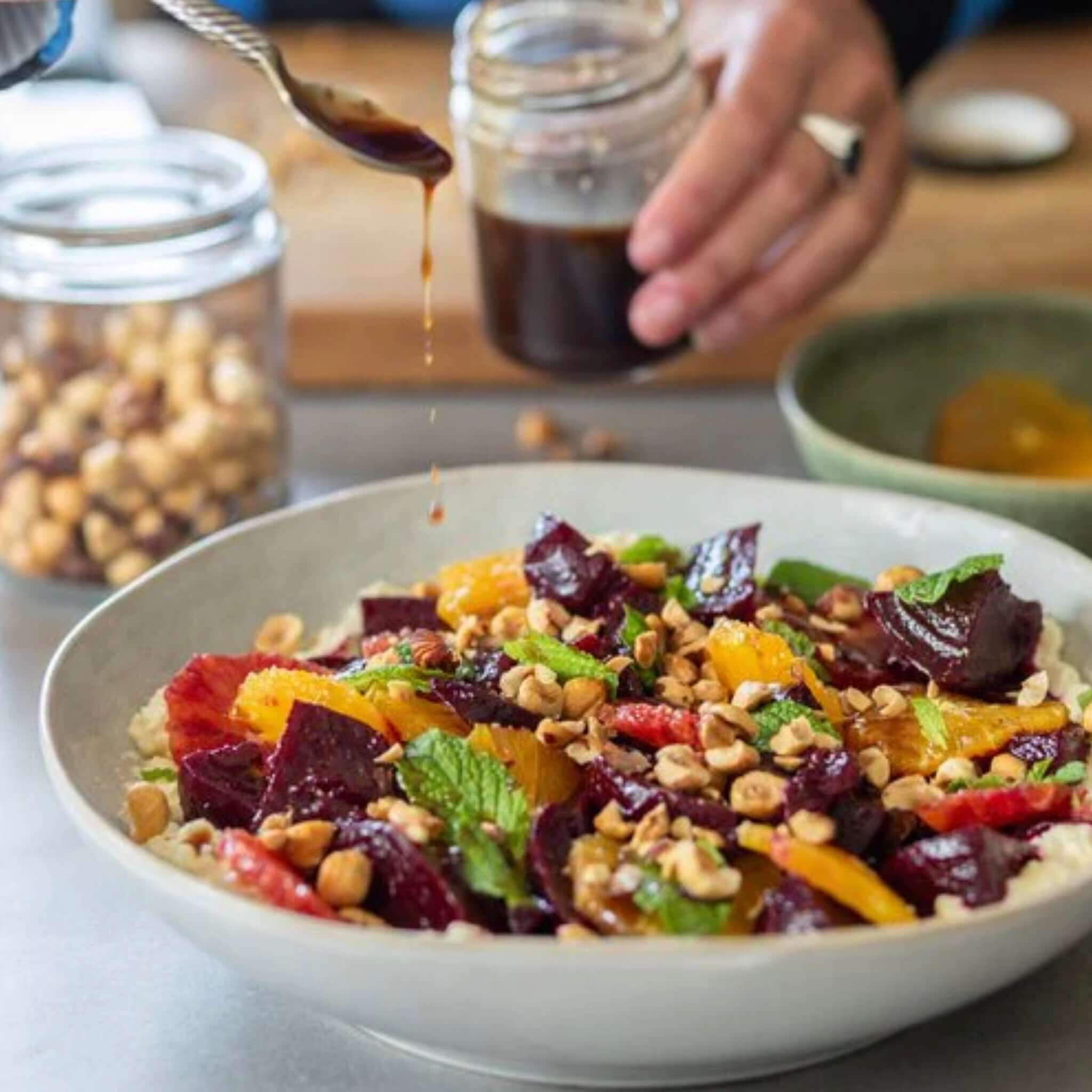 Alt Tag: Everything Salads: Autumn & Winter cookbook image of beet and citrus salad with nuts and dressing drizzle
