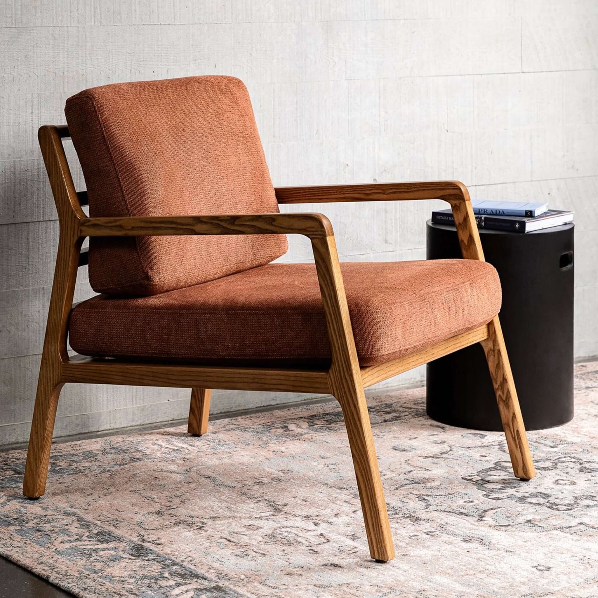 Baker Rubberwood Armchair with natural rubberwood frame and textured upholstered seat in modern living room setting