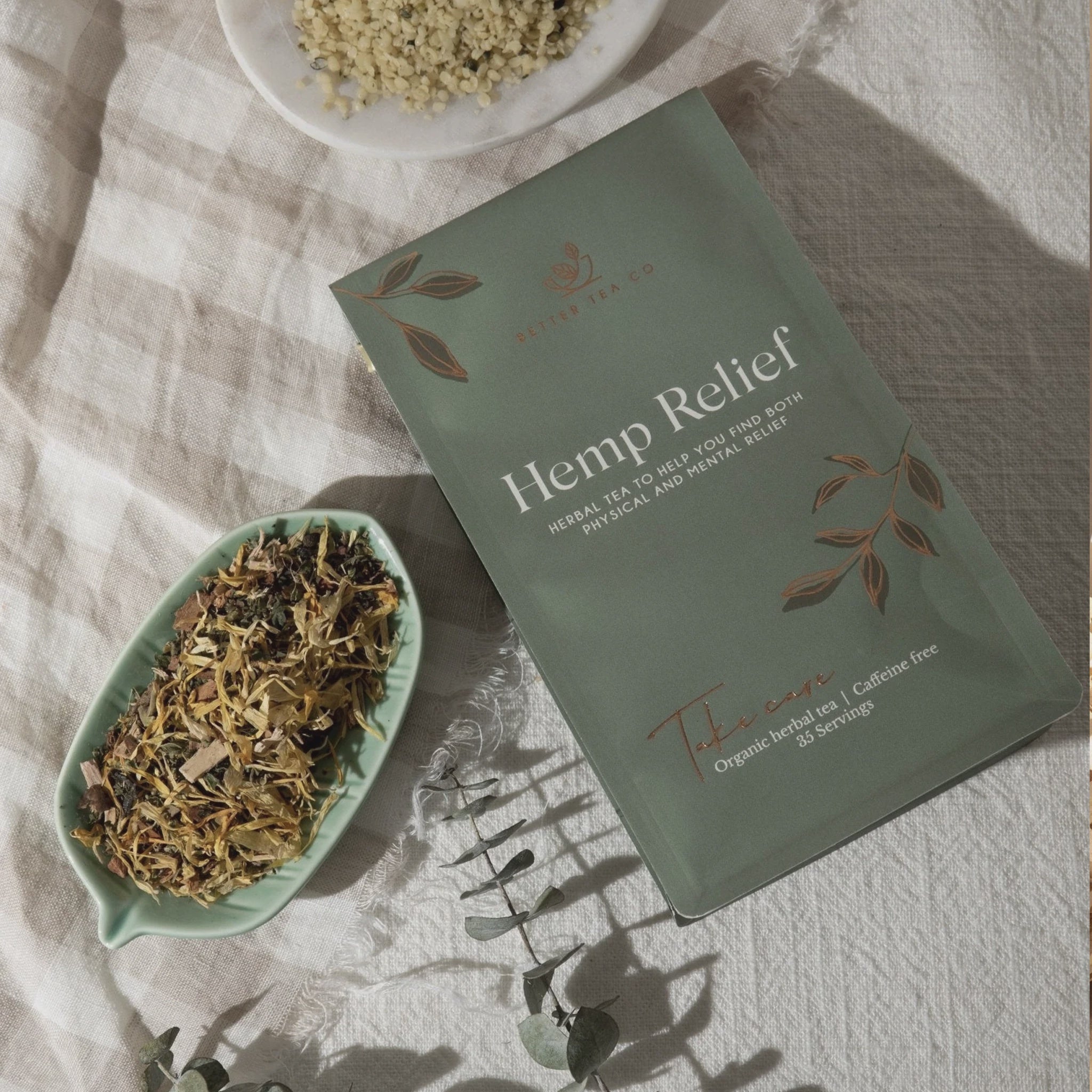 Hemp Relief tea packaging with dried herbs on a textured surface