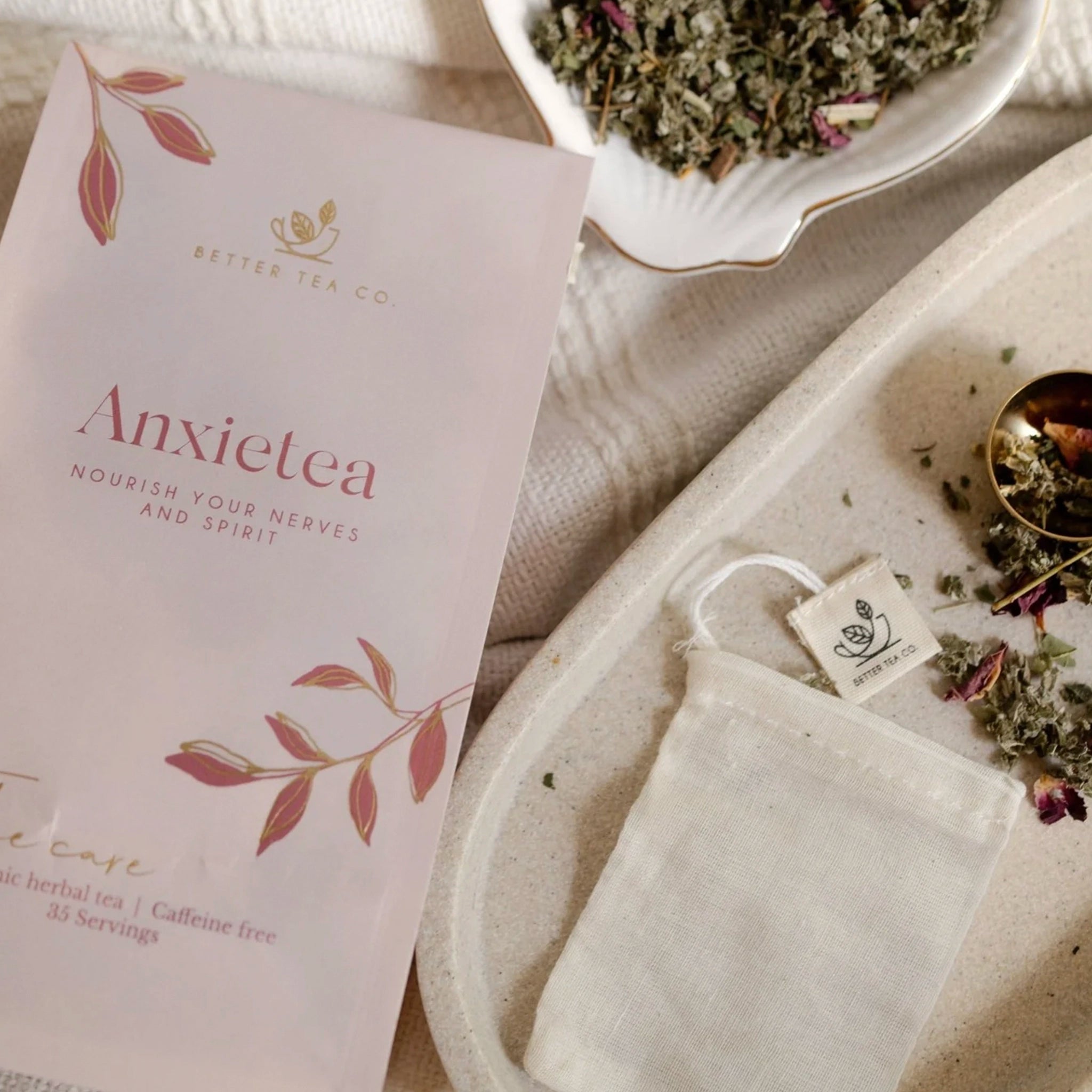 Anxietea tea package with a tea bag and dried herbs on a textured surface