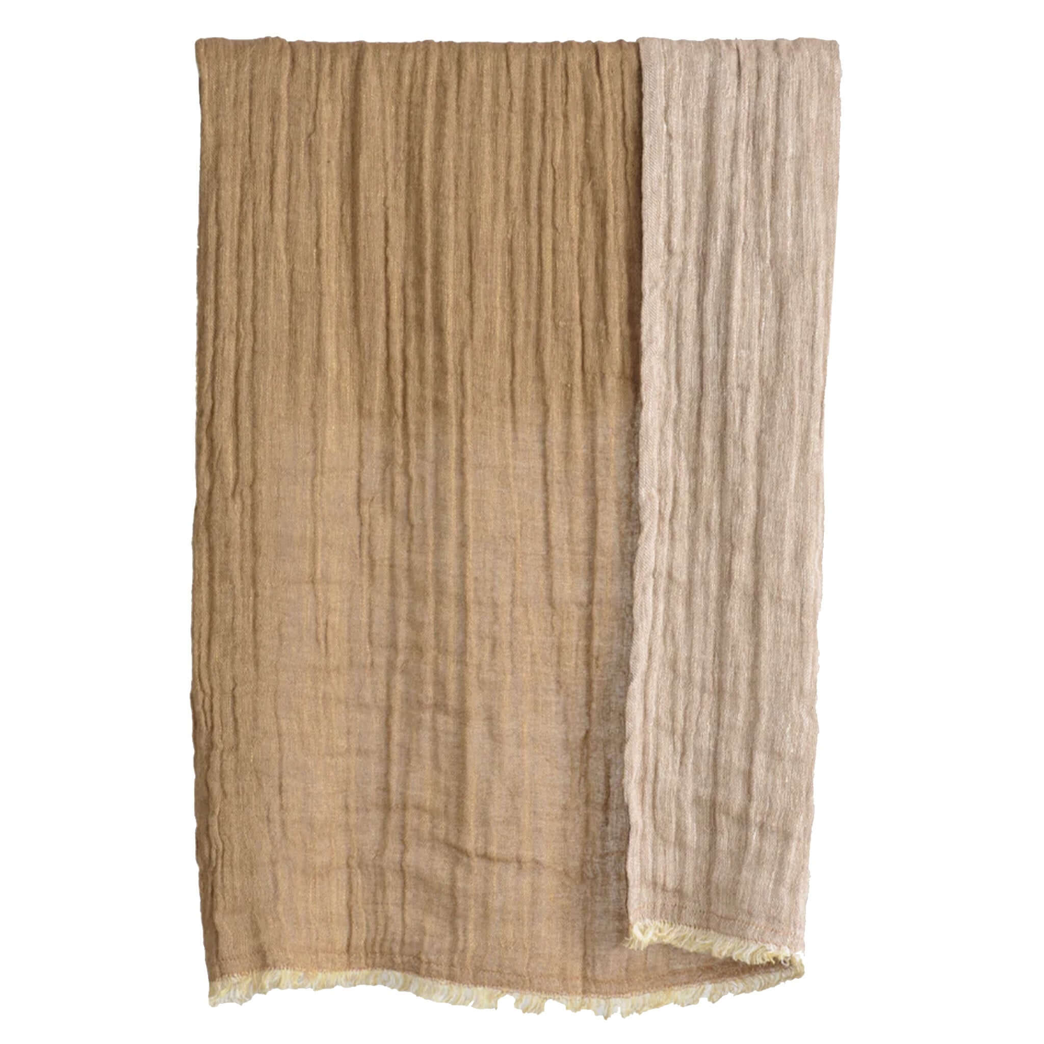Textured brown hand towel with a white border on a white background