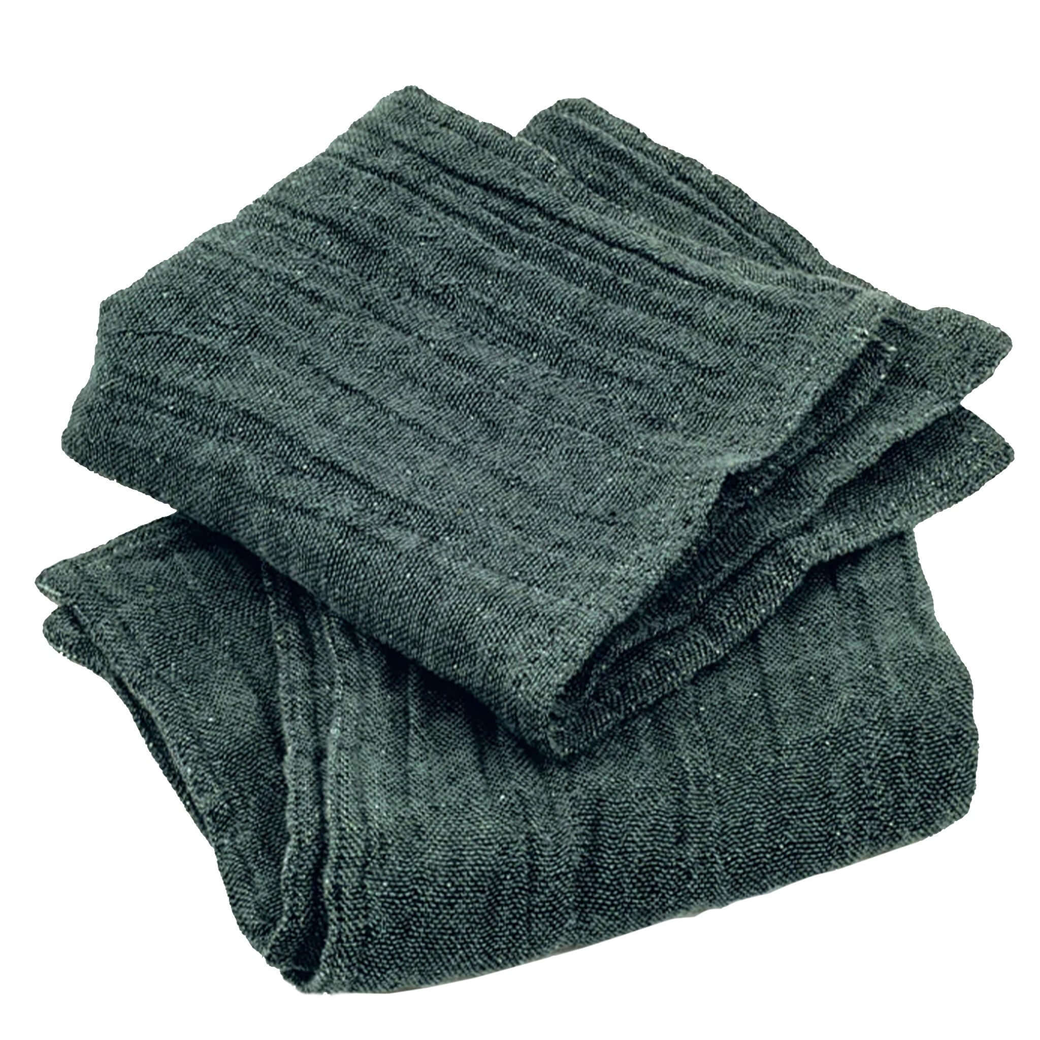 Folded dark green wash cloth on a white background