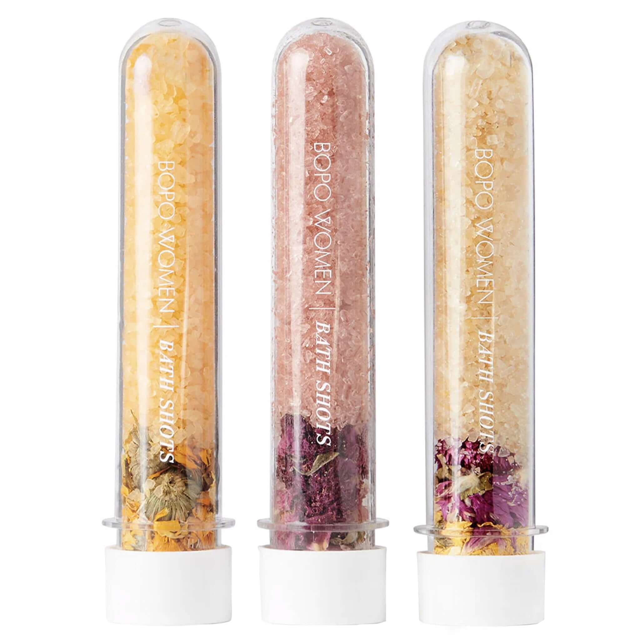 Three transparent tubes filled with bath salts and flowers, branded 'BOPO Women Bath Salts', on a white background.