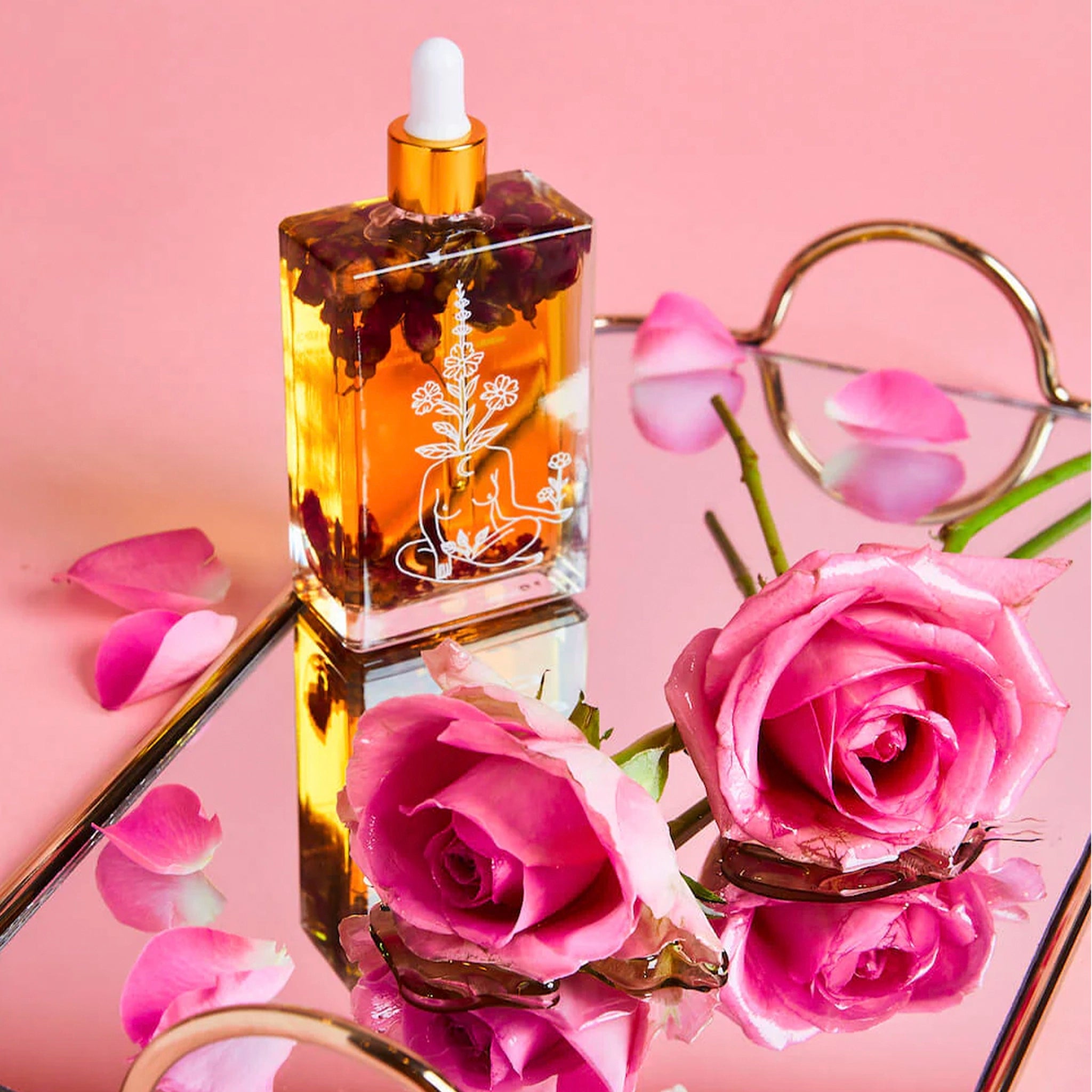 Bottle of Bopo Women self-love body oil with dried flowers on a pink background