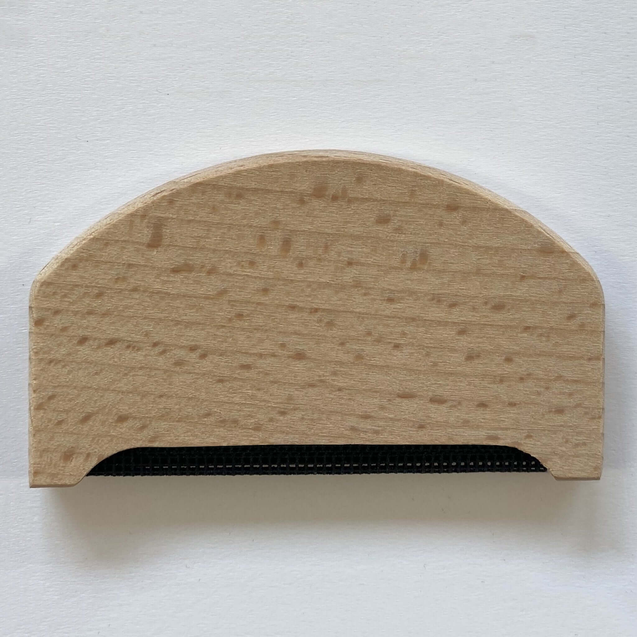 Cashmere Comb wooden tool to remove pilling from cashmere and fine knits for garment care.