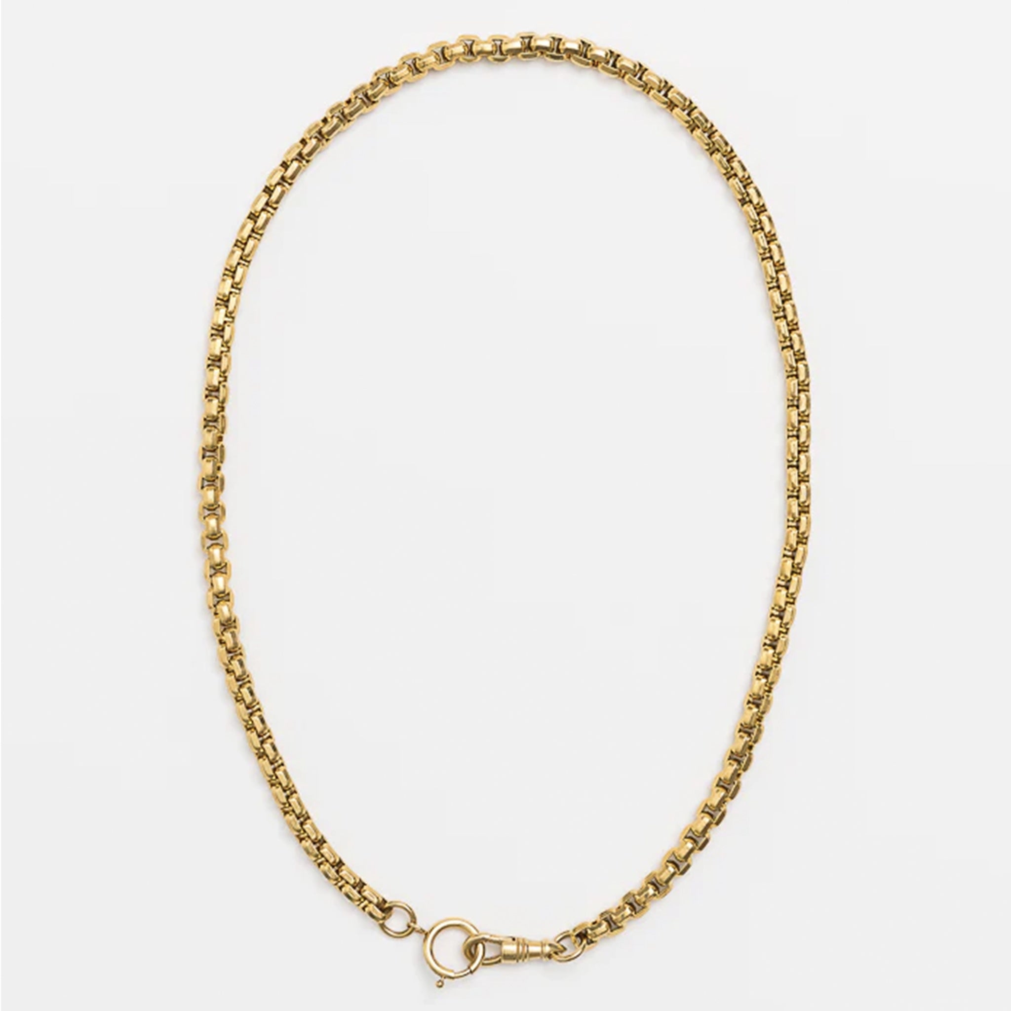 Gold chain necklace on a white background