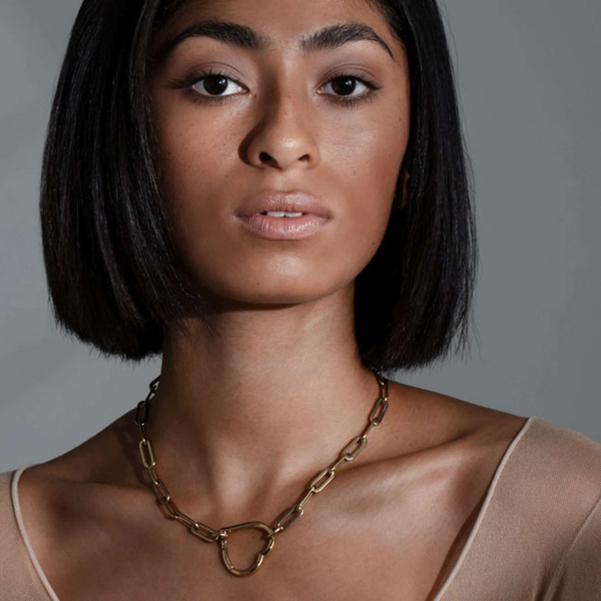 Cathy Pope Long Loop Short Necklace - No Clasp Gold worn by a model, showcasing its elegant design and gold finish.