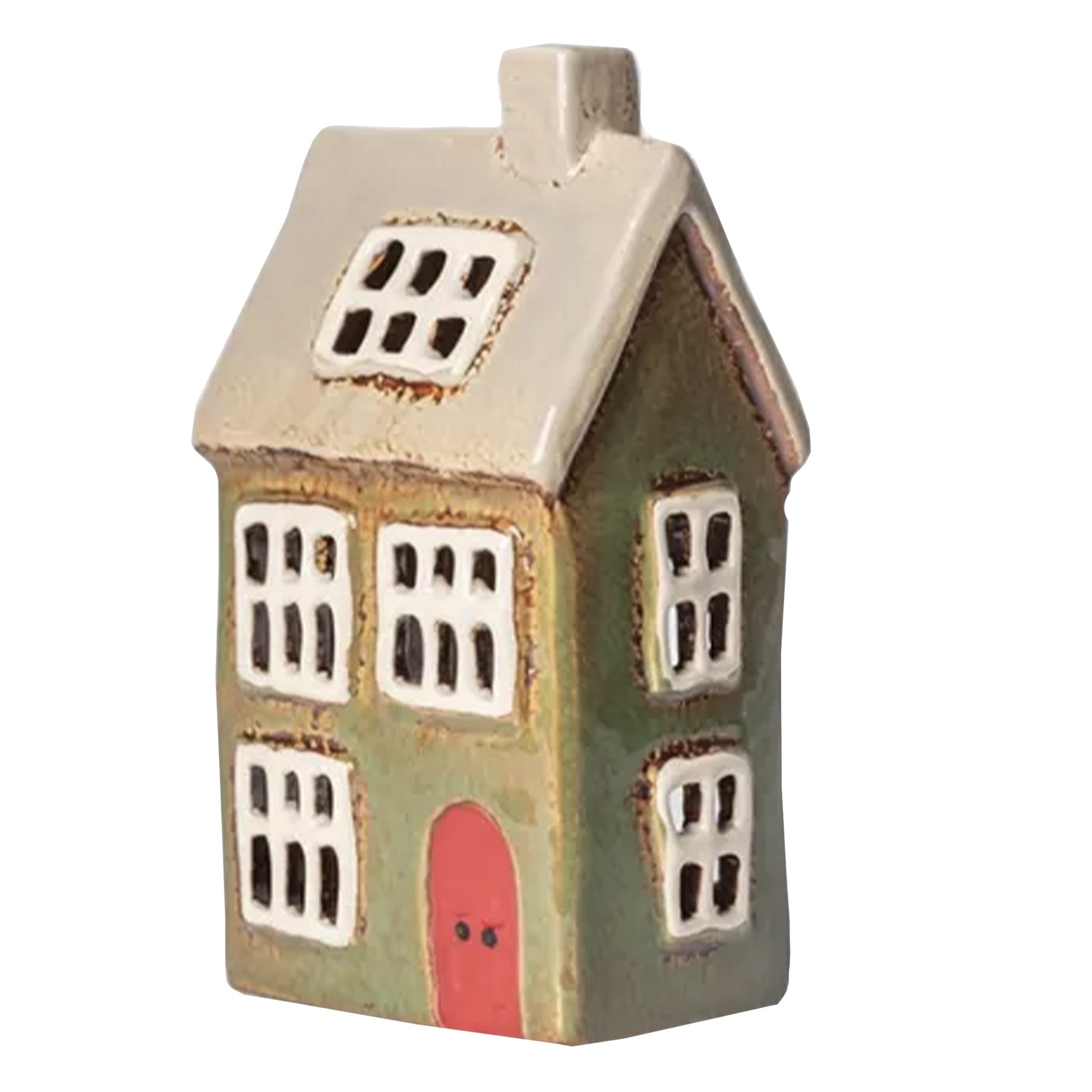 Small ceramic house with a red door on a white background