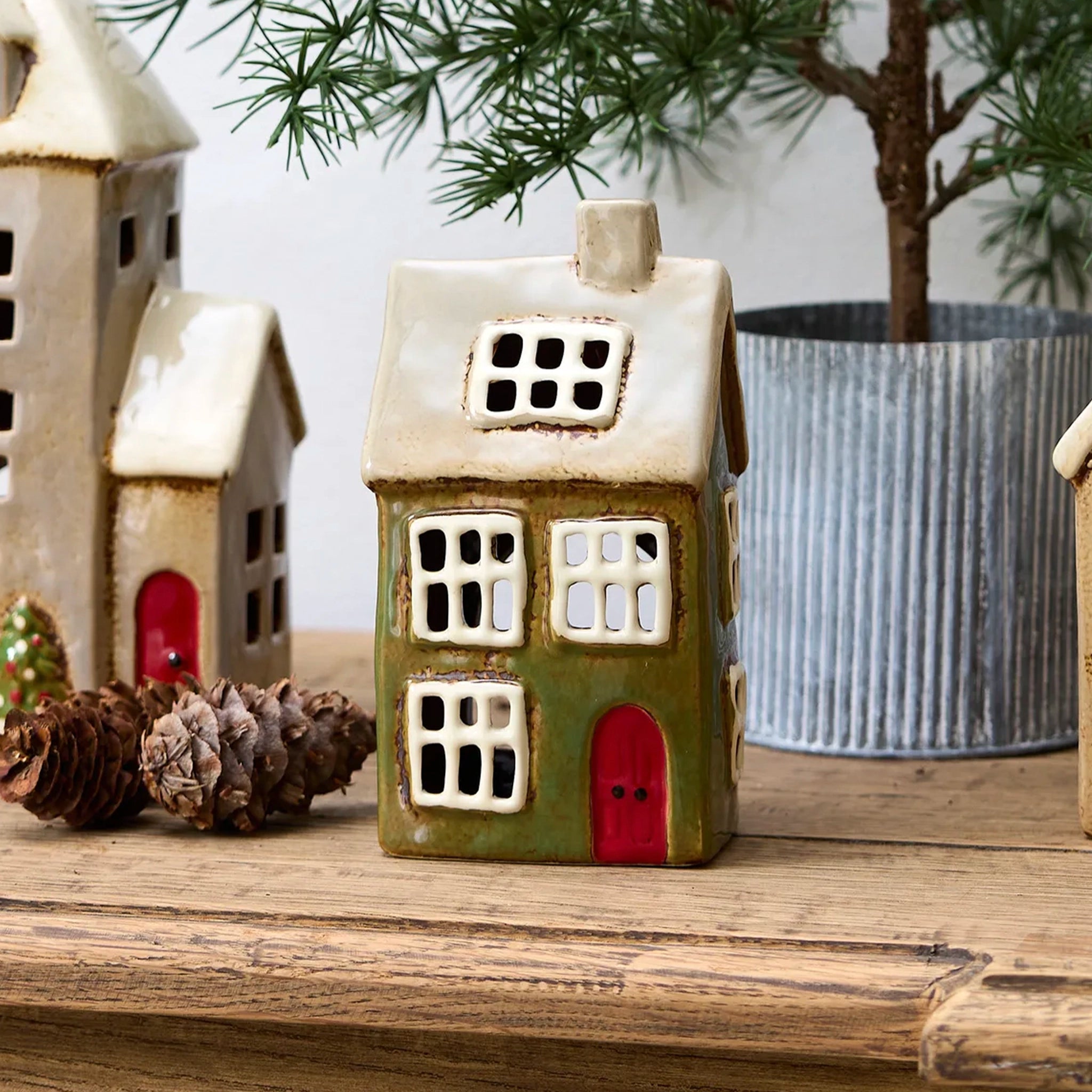 Small ceramic house with a red door on a table