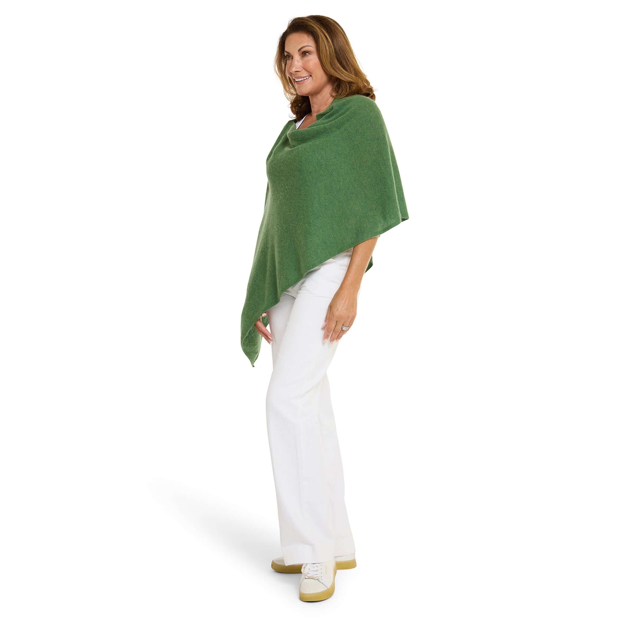 Alt Tag: Esperance & Co Classic Cashmere Topper - Basil worn as a green cashmere wrap poncho layering piece for travel, office and weekend outfits