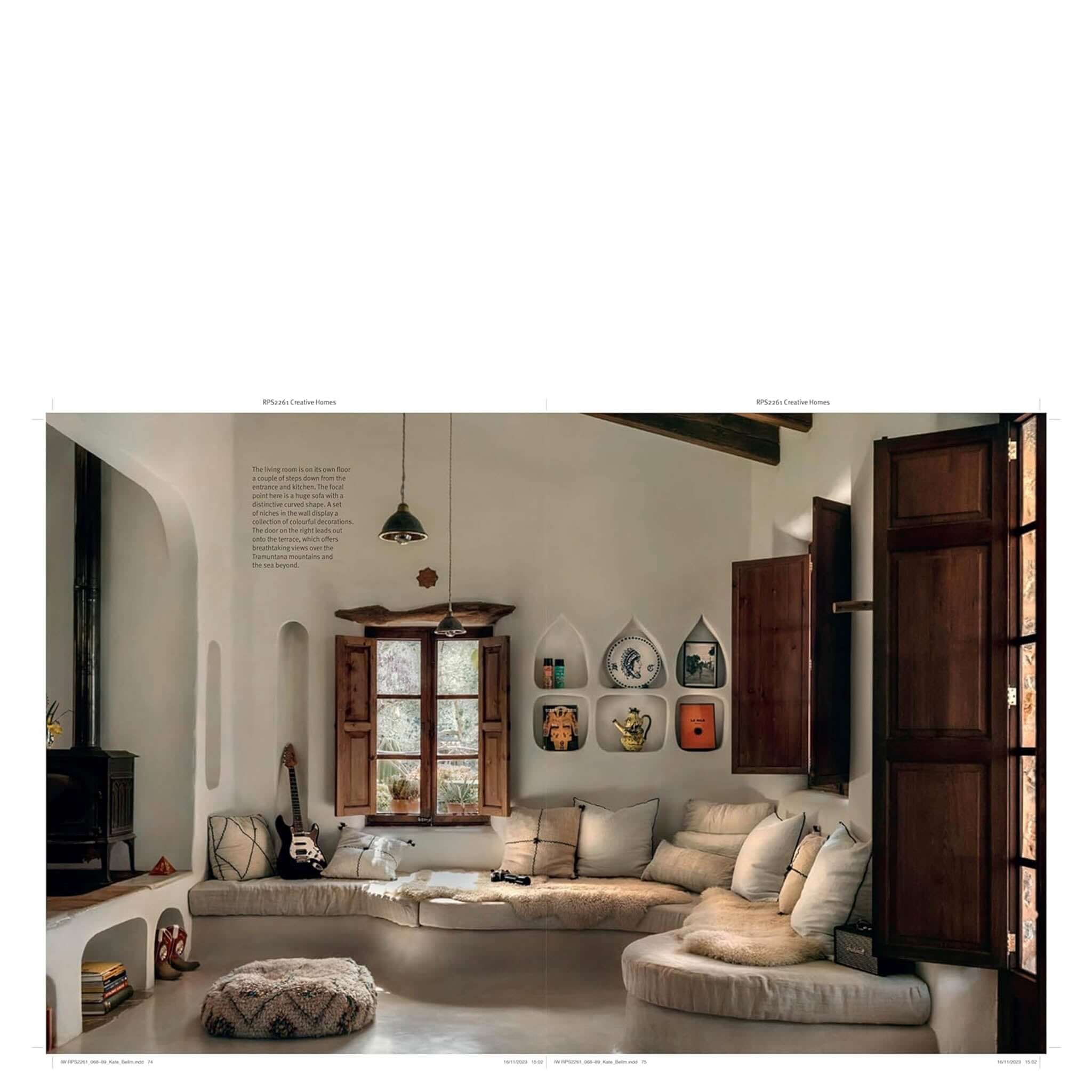 Alt Tag: Creative Homes: Evocative, Eclectic & Carefully Curated Interiors featuring an eclectic sunlit living room with built-in sofa, rustic windows