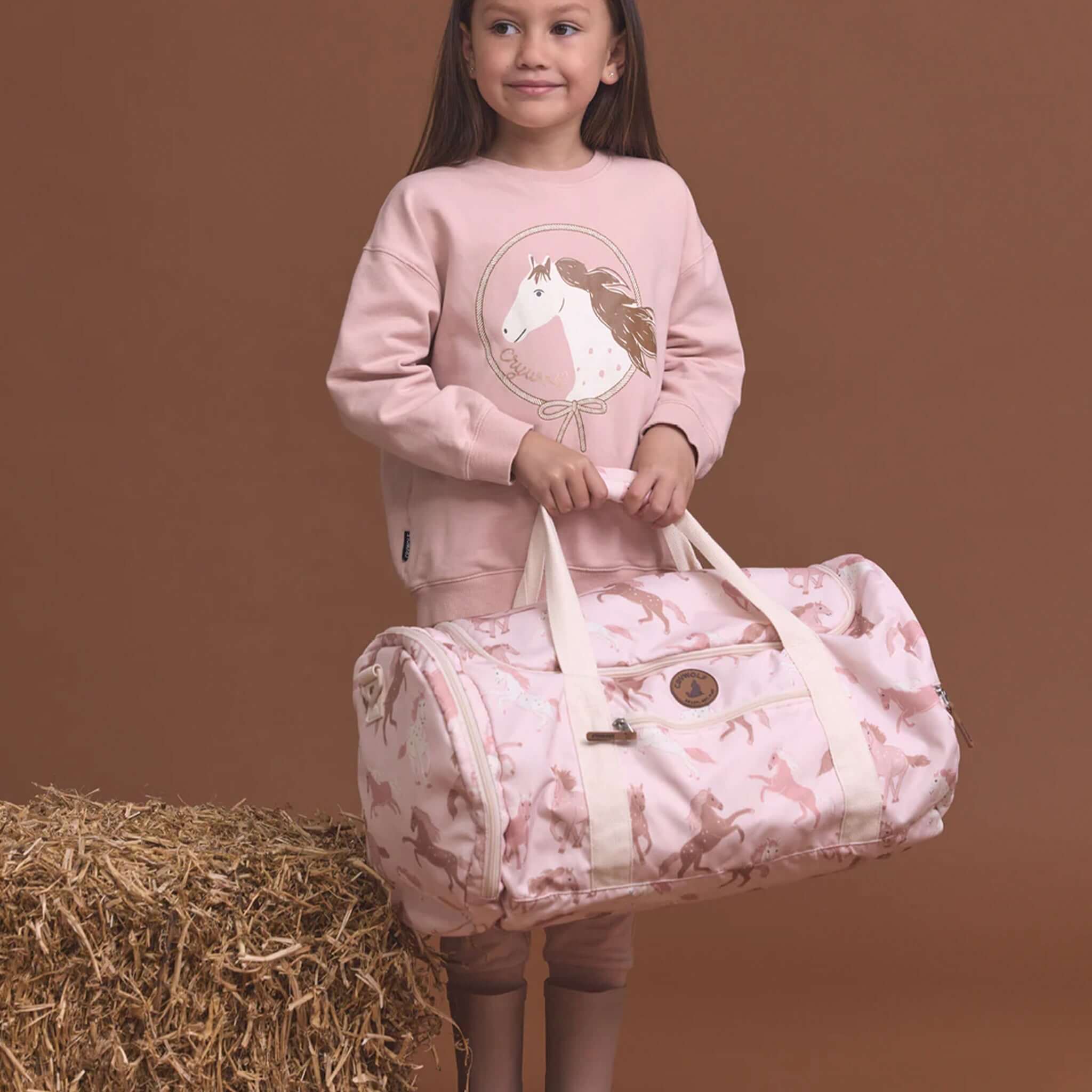 Alt Tag: Crywolf Packable Duffel Bag - Blush Ponies packable kids duffel with wide opening, compartments, blush pony print for travel