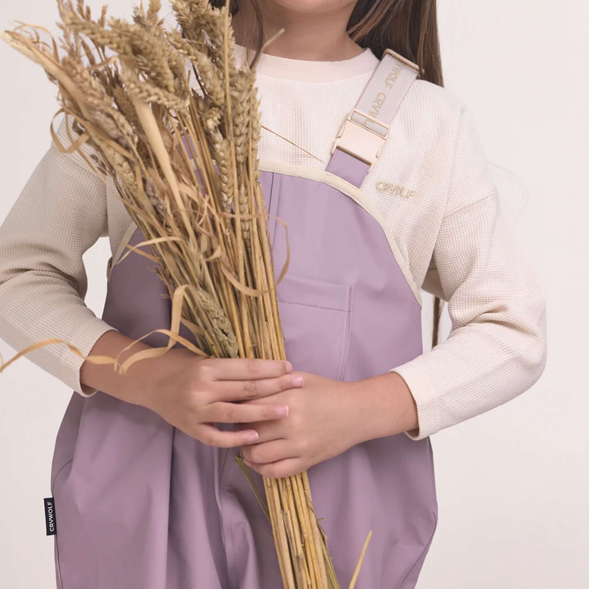 Alt Tag: Crywolf Rain Overalls - Heather on child, fully waterproof adjustable rain bib overalls for outdoor play, kindy and backyard adventures