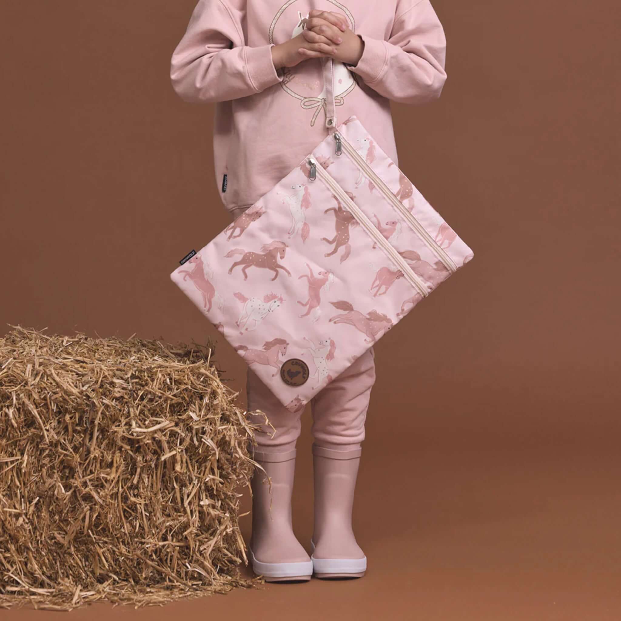 Alt Tag: Crywolf Wet Bag - Blush Ponies pink water-resistant wet bag with dual zip and wrist strap for swimwear, nappies and beach gear