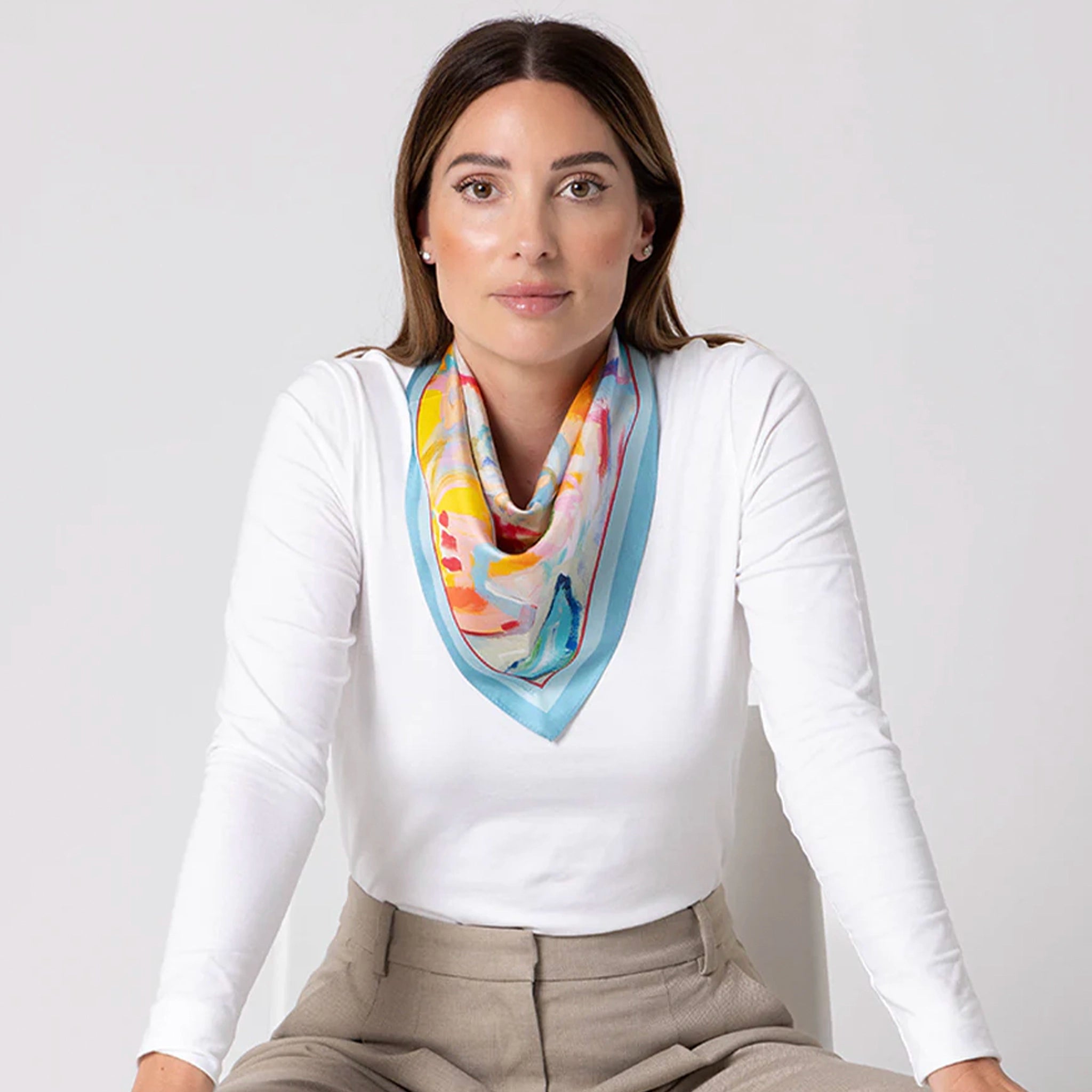 Woman wearing a colorful scarf on a white background