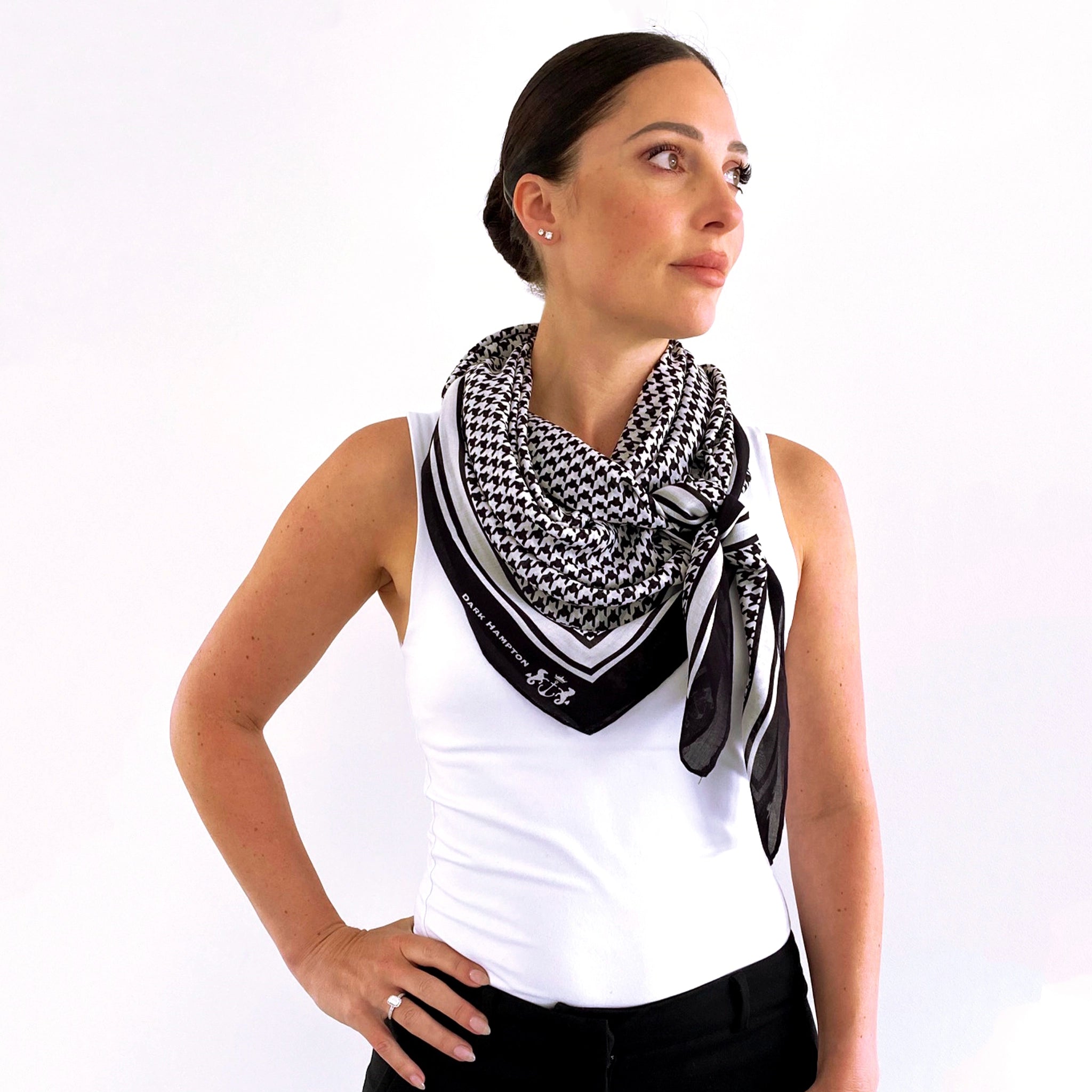 Woman wearing a black and white patterned scarf on a white background