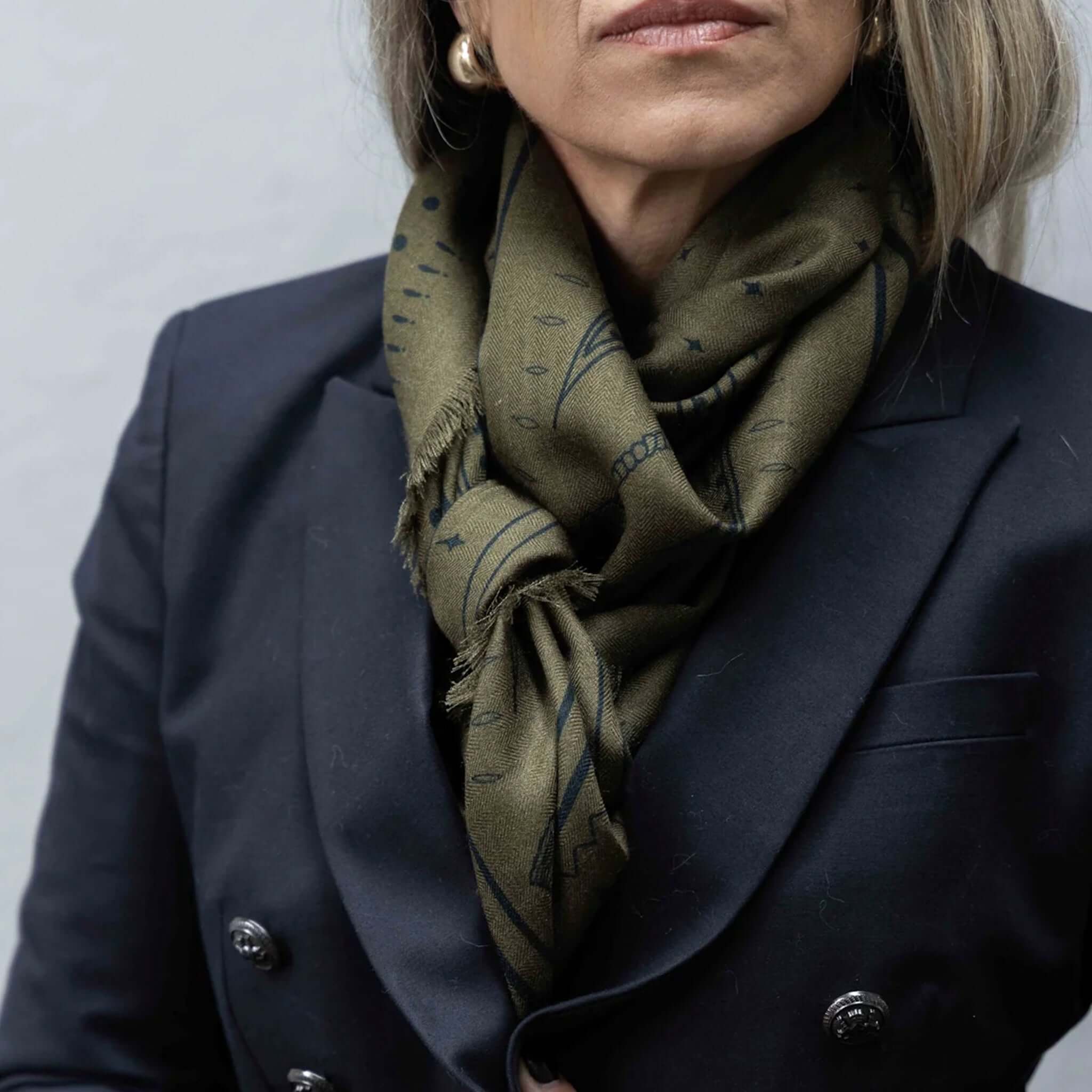 Dark Hampton x Ellie Compton the Yorke Wool Silk Scarf styled in olive and black, showcasing versatile elegance.