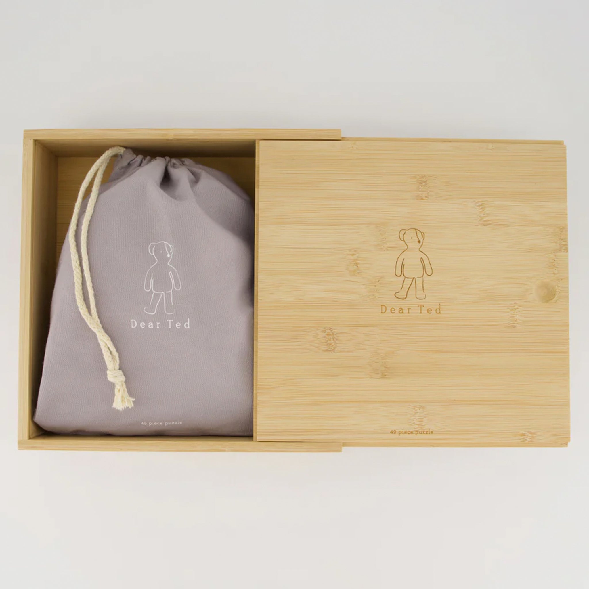 Bamboo box with a gray drawstring bag featuring 'Dear Ted' logo on a light background