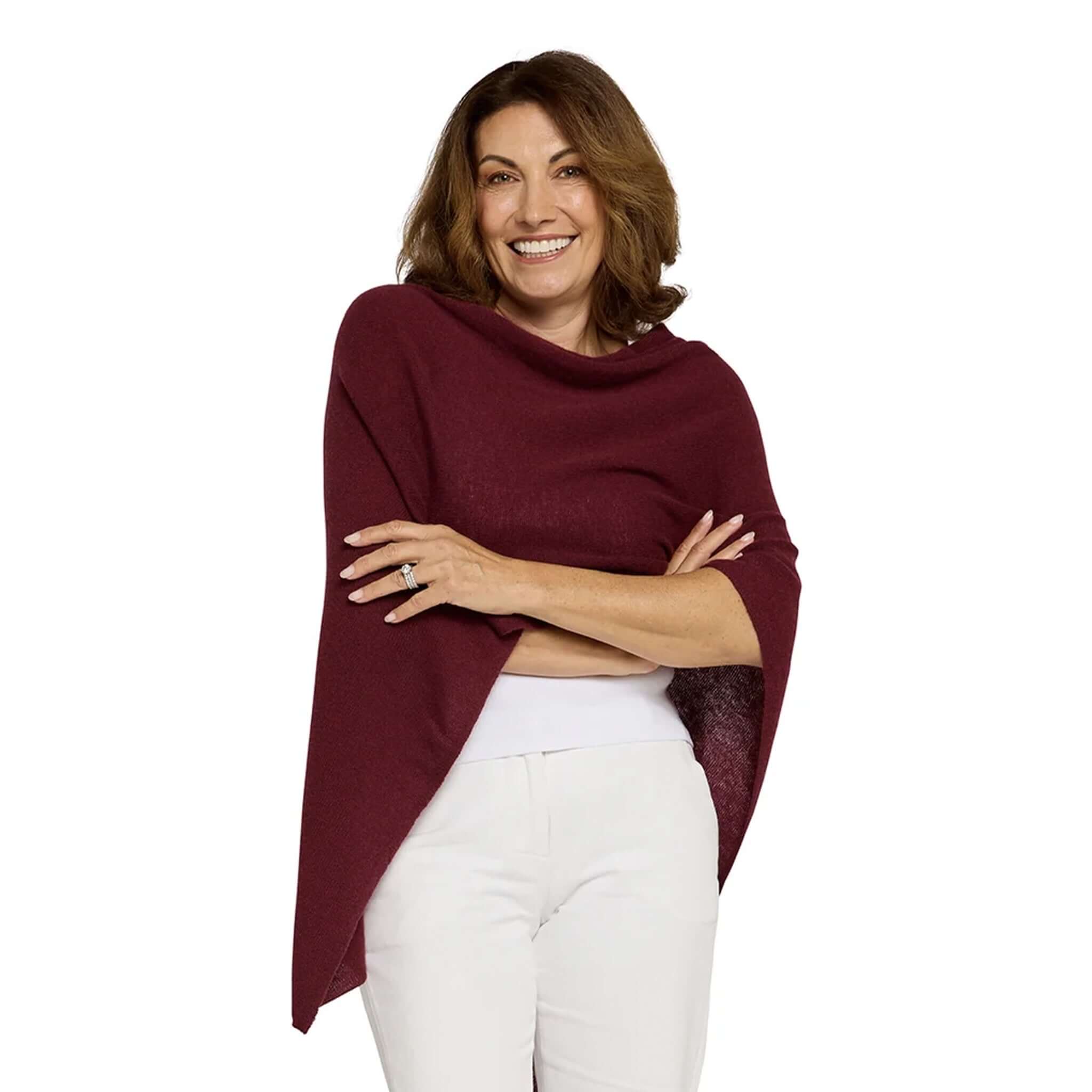 Woman wearing Esperance & Co Classic Cashmere Topper - Sangria, showcasing versatility and style in a fashionable pose.